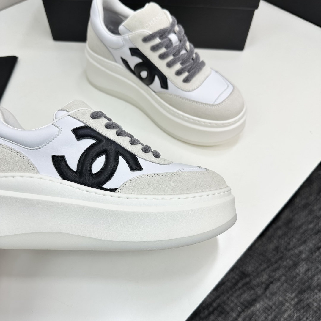 Side view of Chanel white and beige platform sneakers with black CC logo on a black box - Hình 10