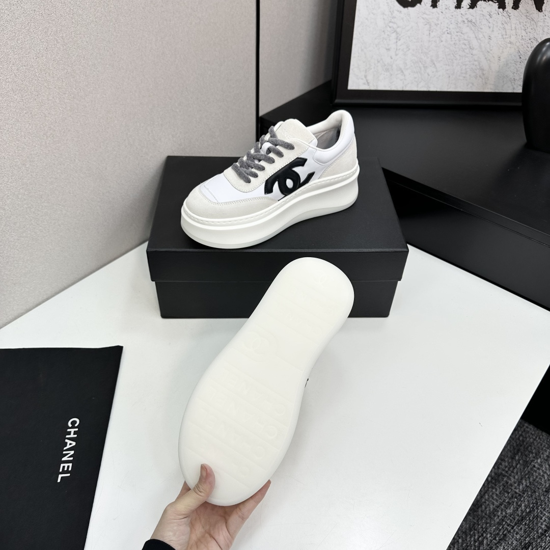 Side view of Chanel white and beige platform sneakers with black CC logo on a black box - Hình 5