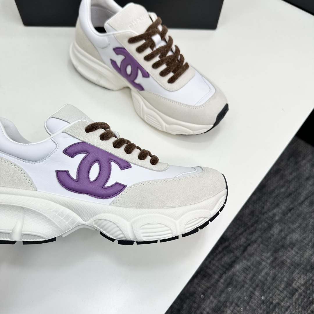 Luxury Chanel sneakers in white leather and beige suede featuring a purple CC logo and chunky white sole. - Hình 10