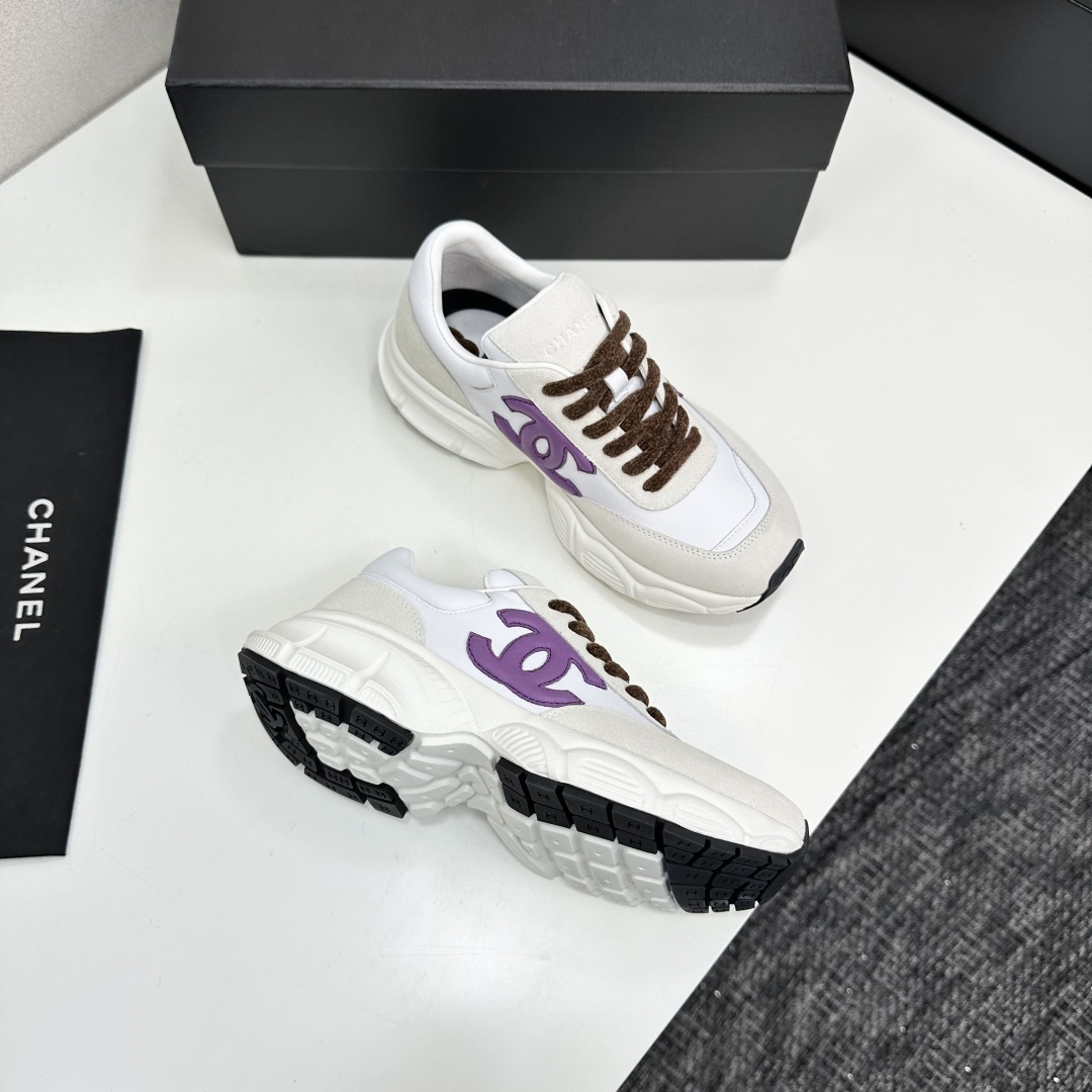 Luxury Chanel sneakers in white leather and beige suede featuring a purple CC logo and chunky white sole. - Hình 9
