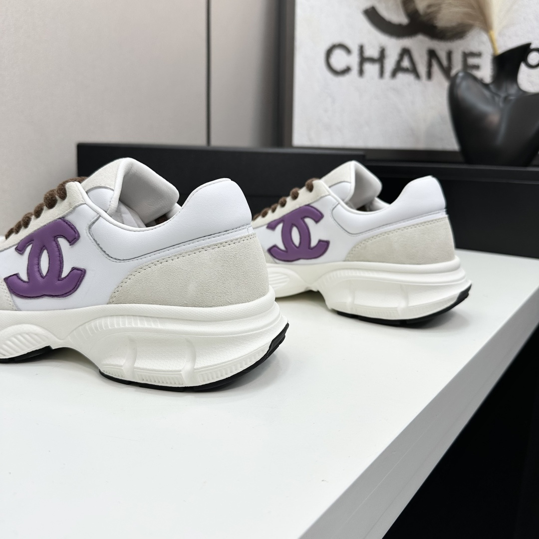 Luxury Chanel sneakers in white leather and beige suede featuring a purple CC logo and chunky white sole. - Hình 8