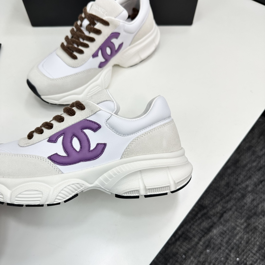 Luxury Chanel sneakers in white leather and beige suede featuring a purple CC logo and chunky white sole. - Hình 7