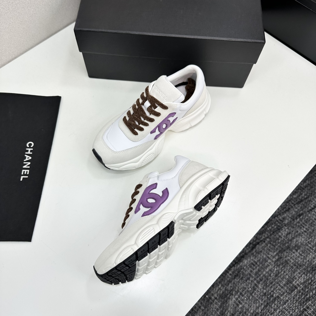 Luxury Chanel sneakers in white leather and beige suede featuring a purple CC logo and chunky white sole. - Hình 6