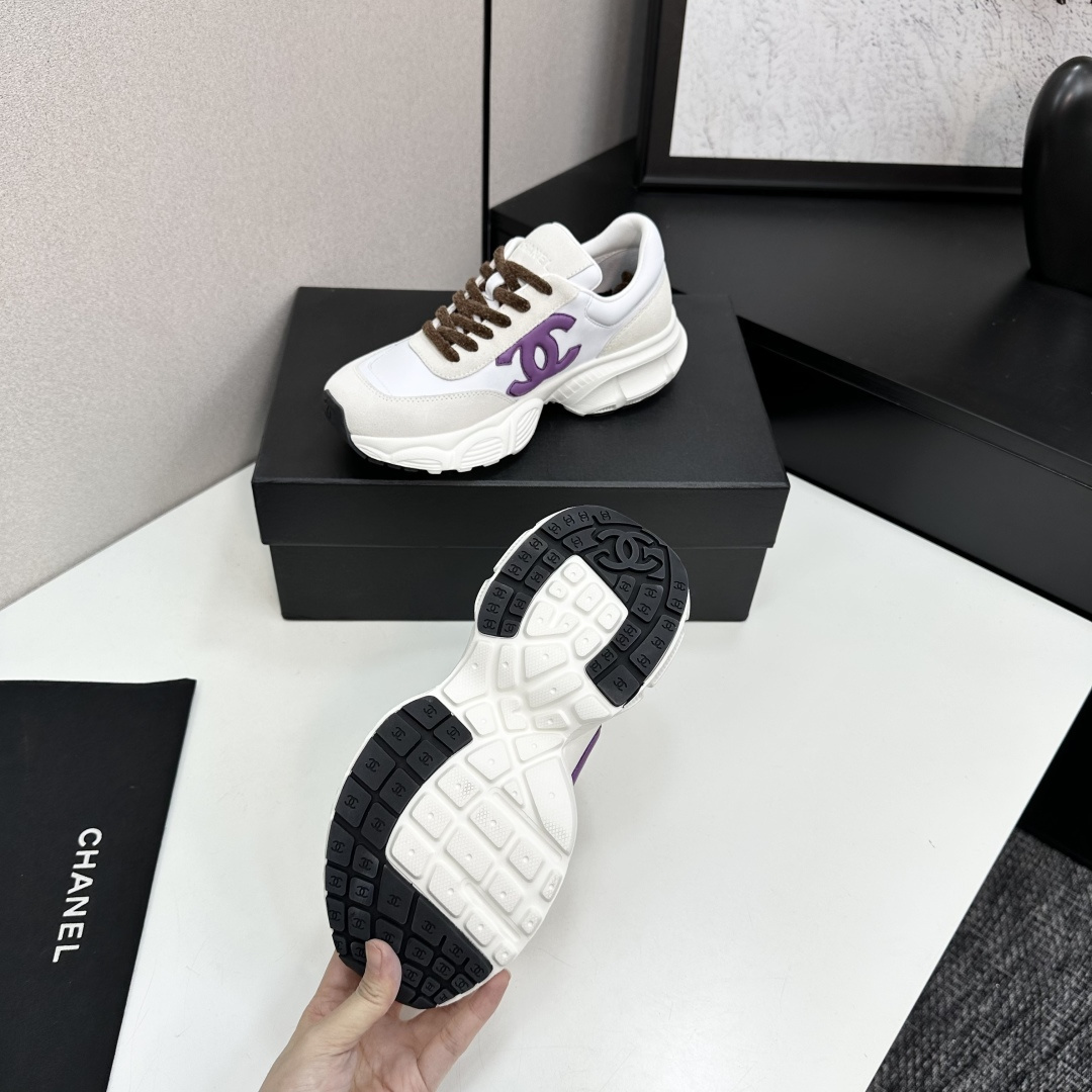 Luxury Chanel sneakers in white leather and beige suede featuring a purple CC logo and chunky white sole. - Hình 5
