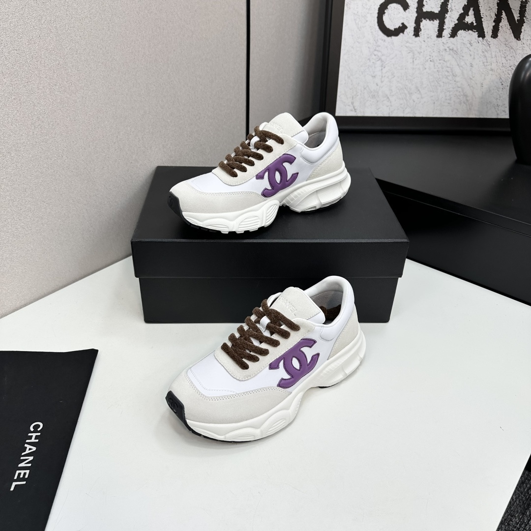 Luxury Chanel sneakers in white leather and beige suede featuring a purple CC logo and chunky white sole. - Hình 3