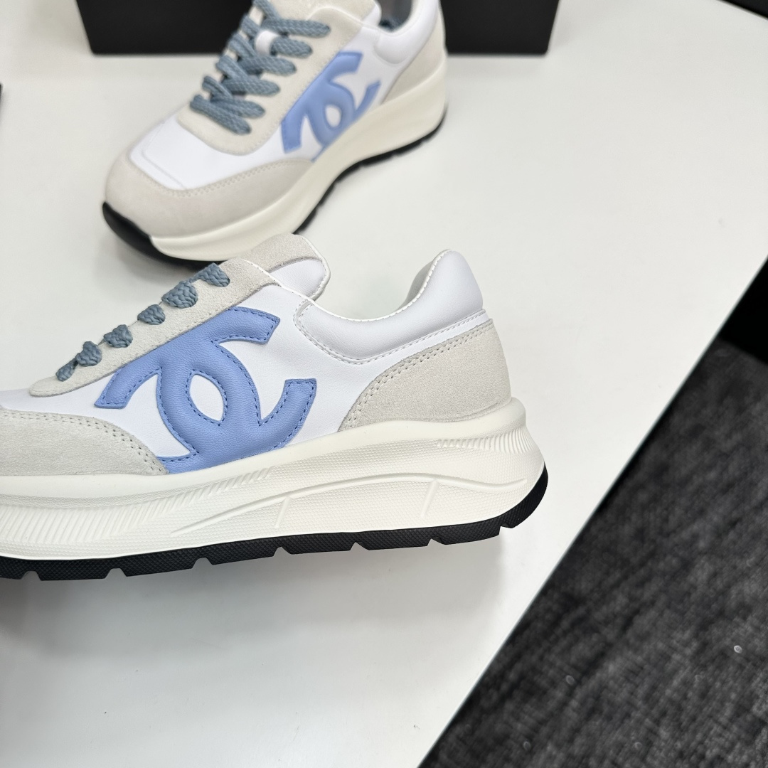 A pair of Chanel sneakers in white and light blue featuring the CC logo on the side - Hình 9