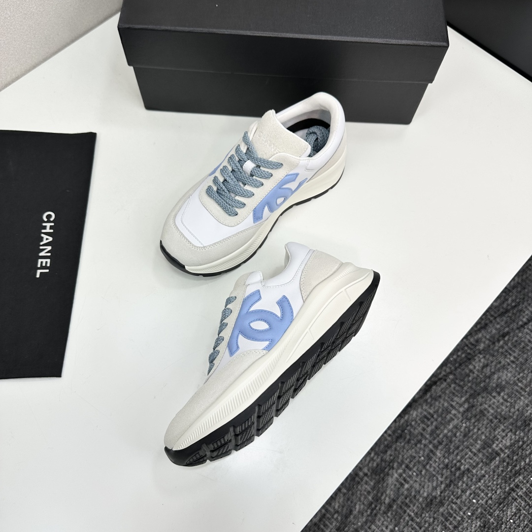 A pair of Chanel sneakers in white and light blue featuring the CC logo on the side - Hình 8