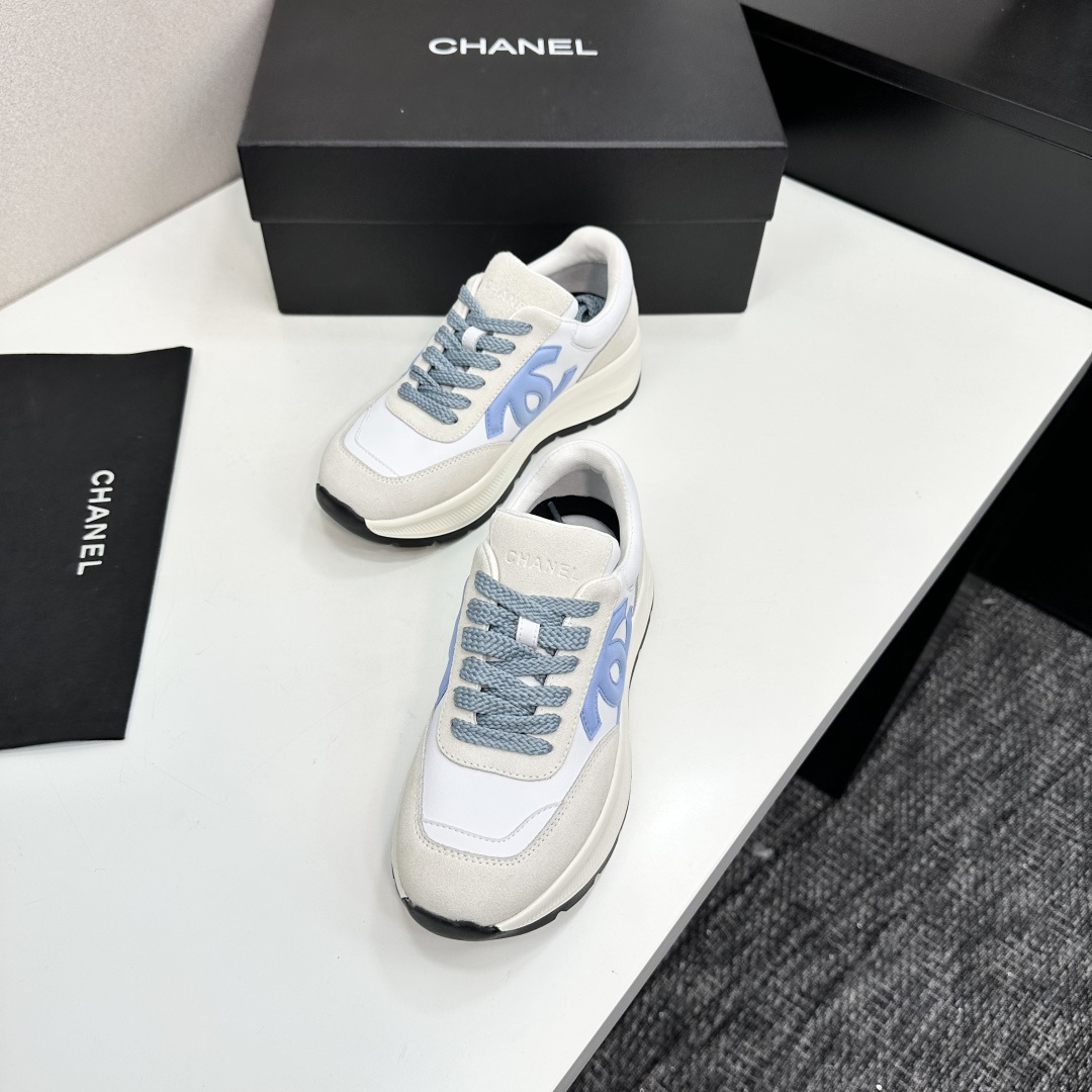 A pair of Chanel sneakers in white and light blue featuring the CC logo on the side - Hình 7
