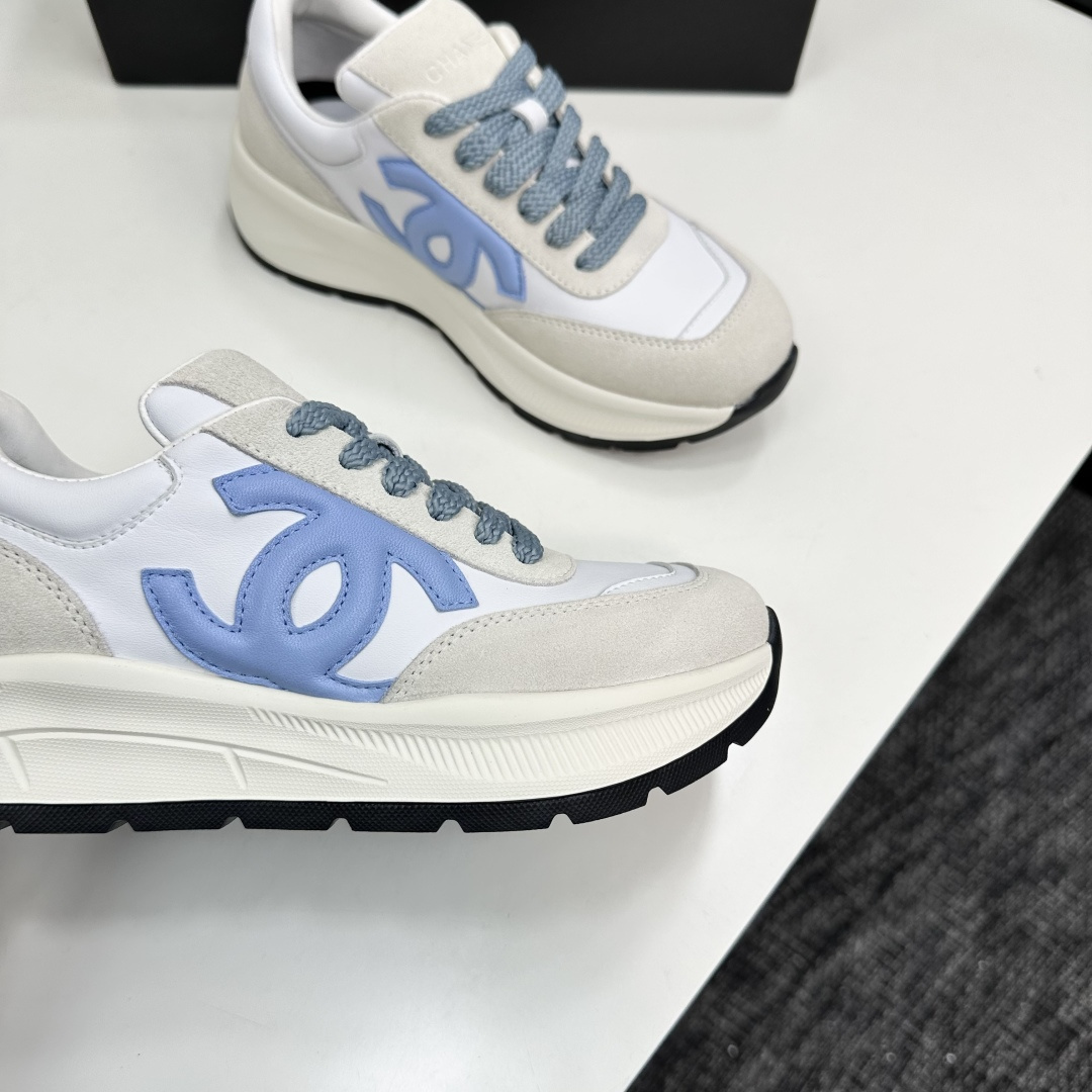 A pair of Chanel sneakers in white and light blue featuring the CC logo on the side - Hình 2
