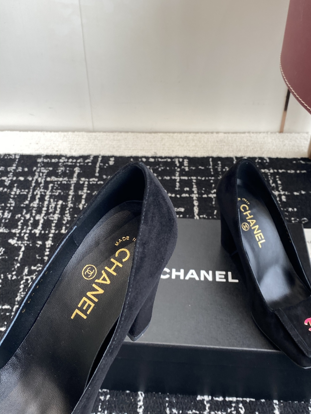 Authentic Chanel black suede pumps with square toe and pink CC logo turn-lock detail on a black box. - Hình 7