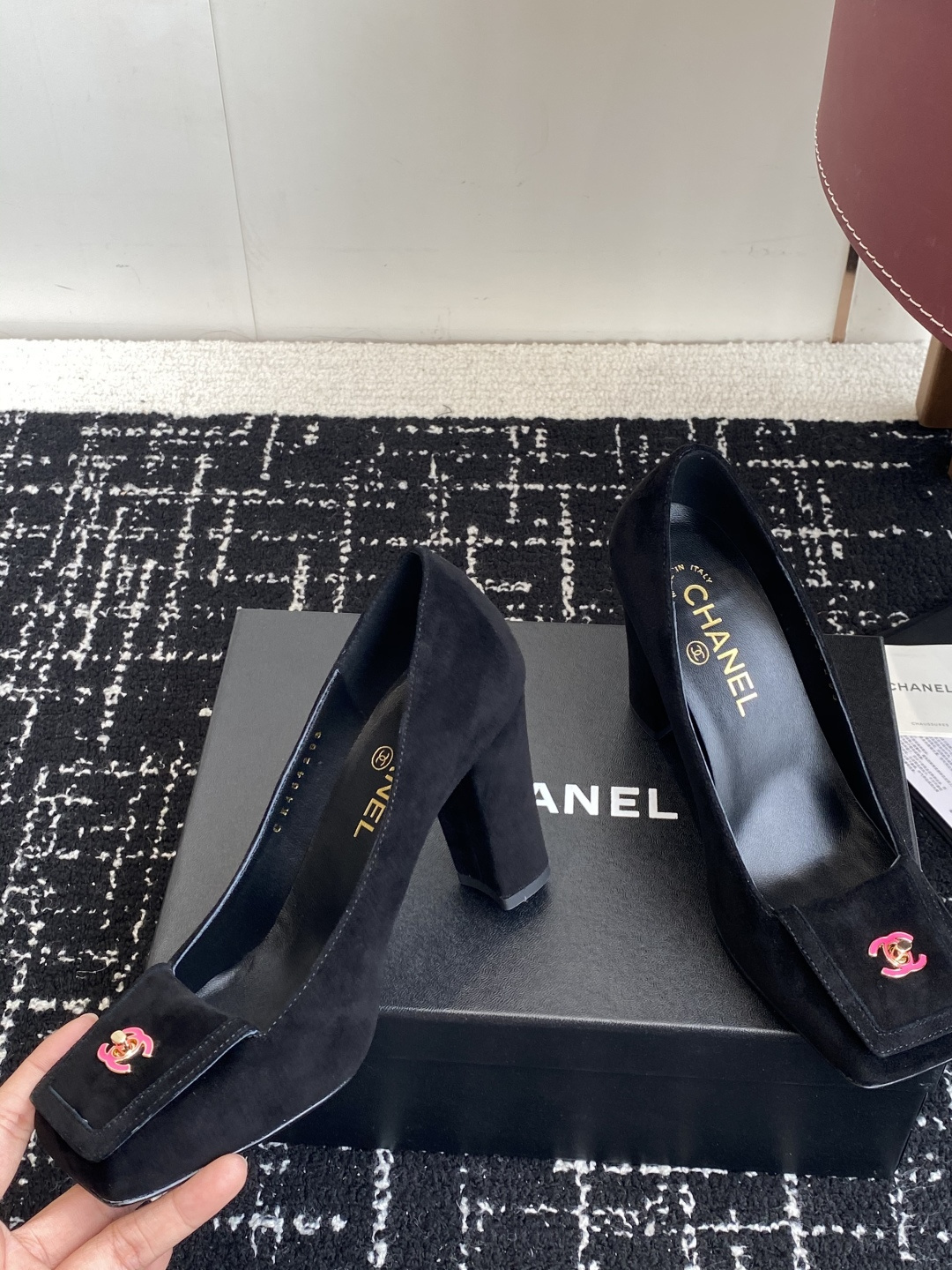 Authentic Chanel black suede pumps with square toe and pink CC logo turn-lock detail on a black box. - Hình 6
