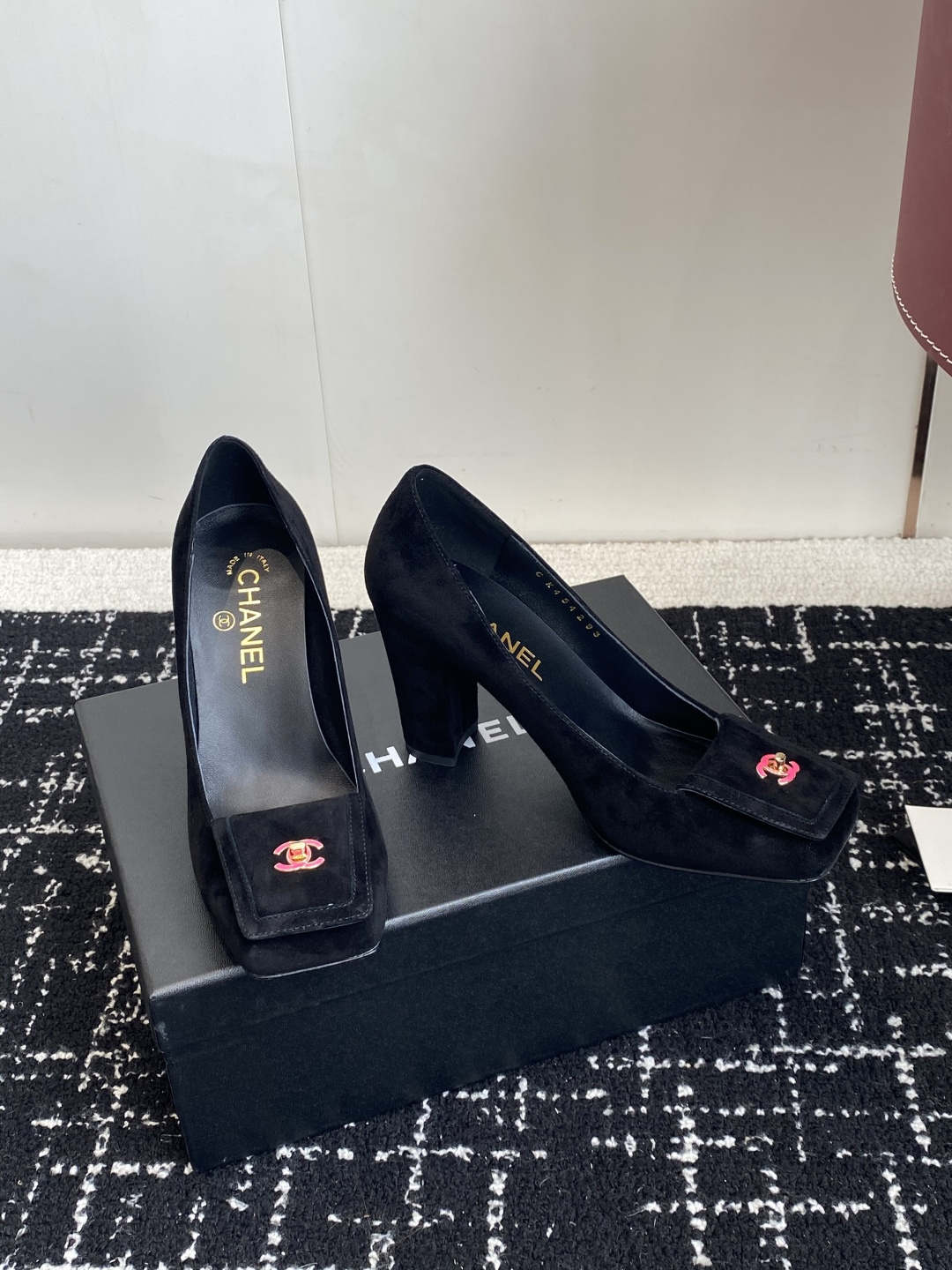 Authentic Chanel black suede pumps with square toe and pink CC logo turn-lock detail on a black box. - Hình 3
