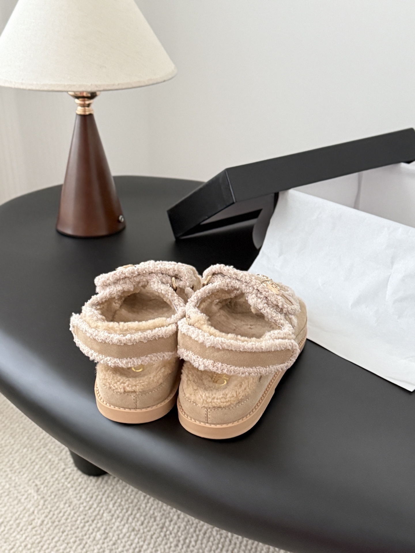 Luxury Chanel beige shearling dad sandals with gold CC logo buttons and fluffy lining placed next to a Chanel box. - Hình 8