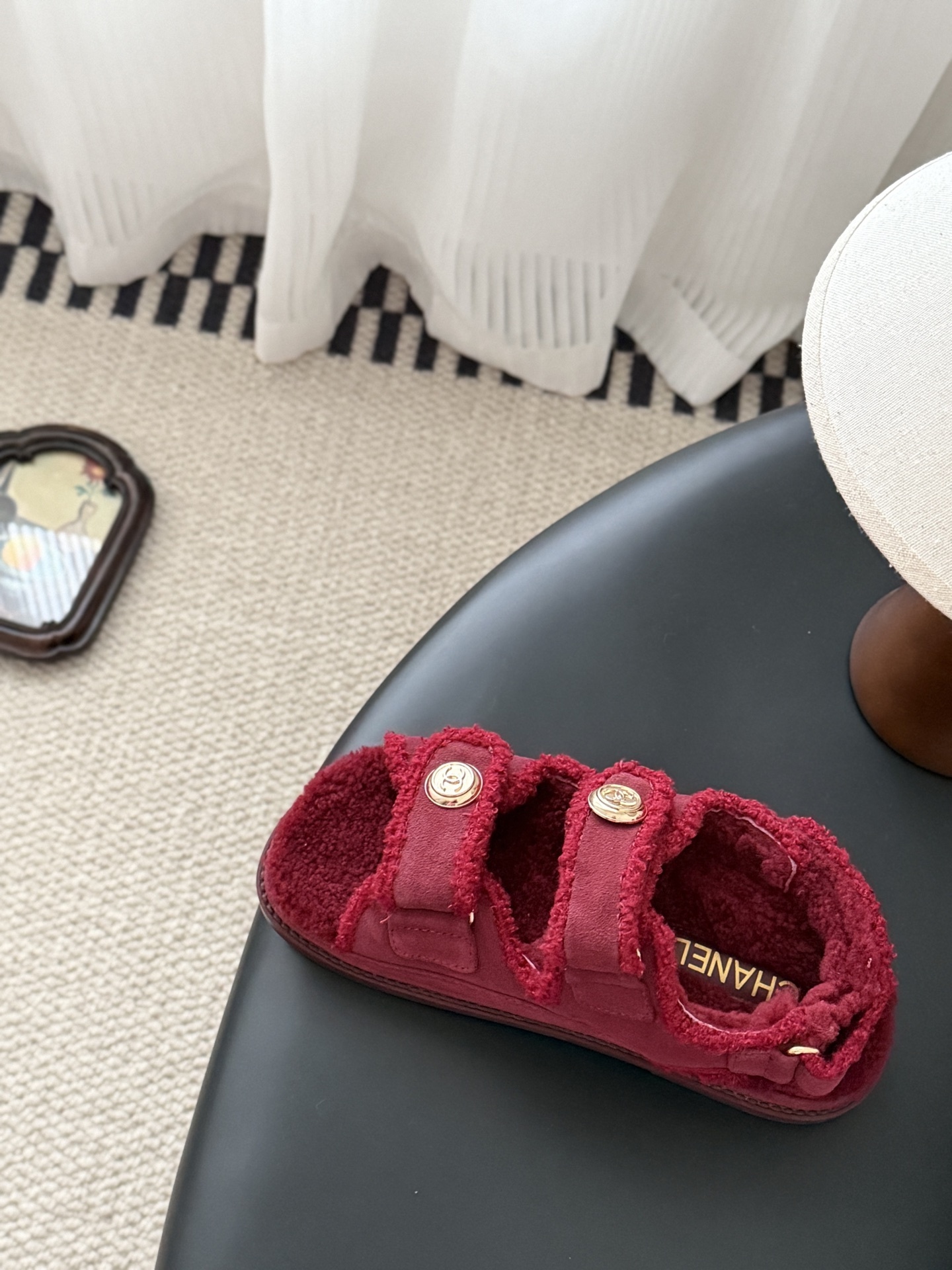 Top view of red Chanel shearling sandals with gold CC logo buttons and black designer box - Hình 8