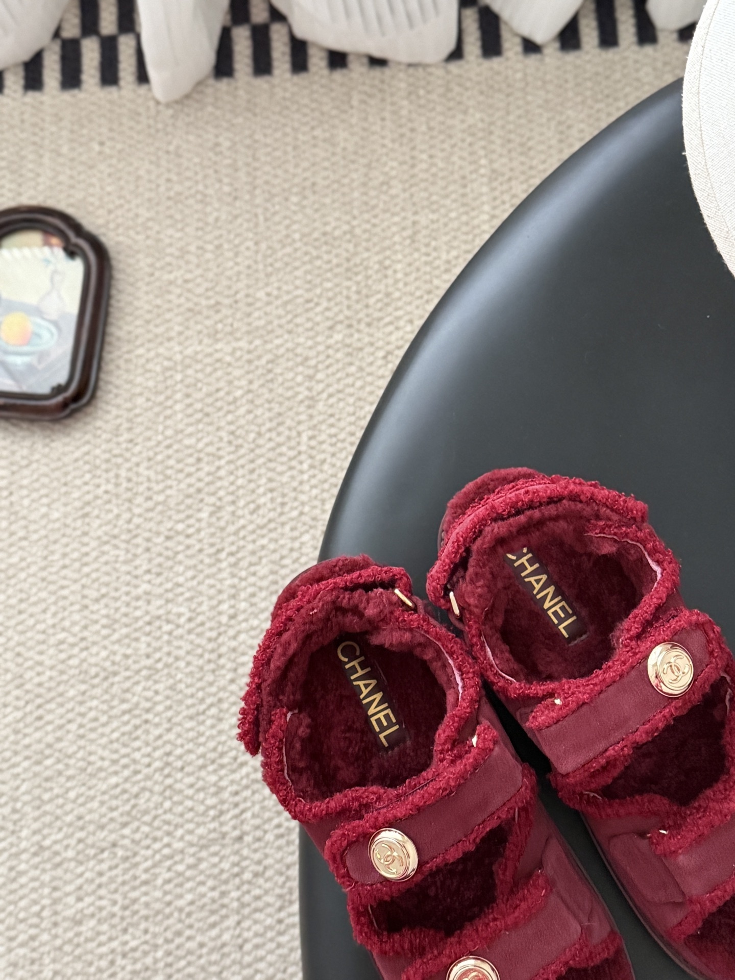 Top view of red Chanel shearling sandals with gold CC logo buttons and black designer box - Hình 7
