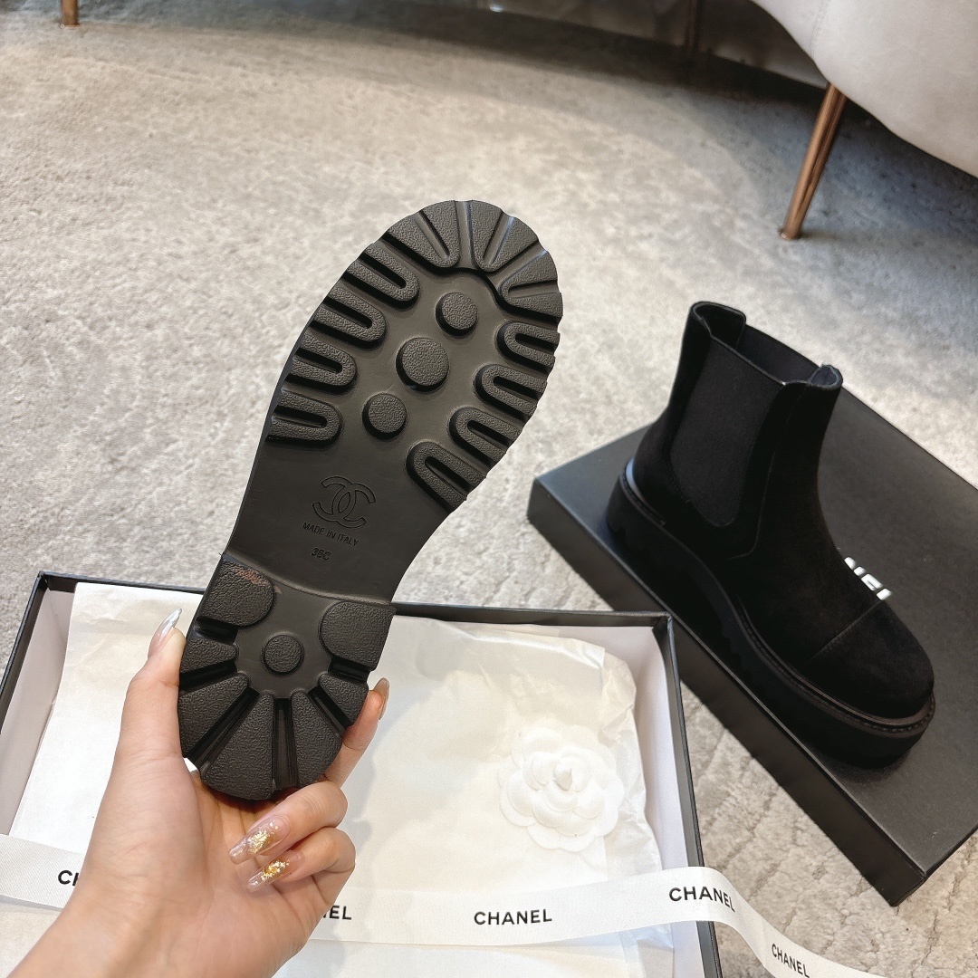 A pair of Chanel black suede platform Chelsea boots with a chunky lug sole and small silver CC logo, displayed with original luxury packaging. - Hình 9