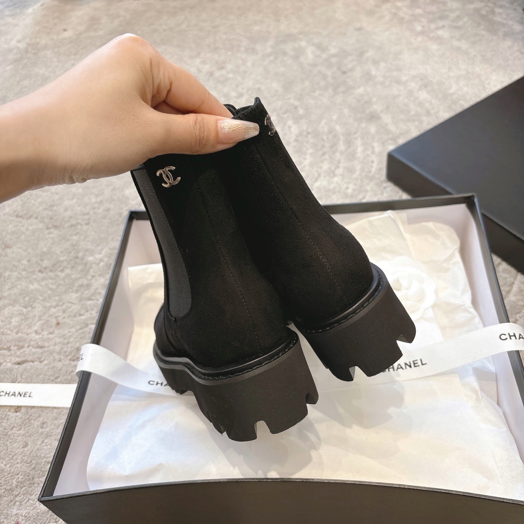 A pair of Chanel black suede platform Chelsea boots with a chunky lug sole and small silver CC logo, displayed with original luxury packaging. - Hình 8