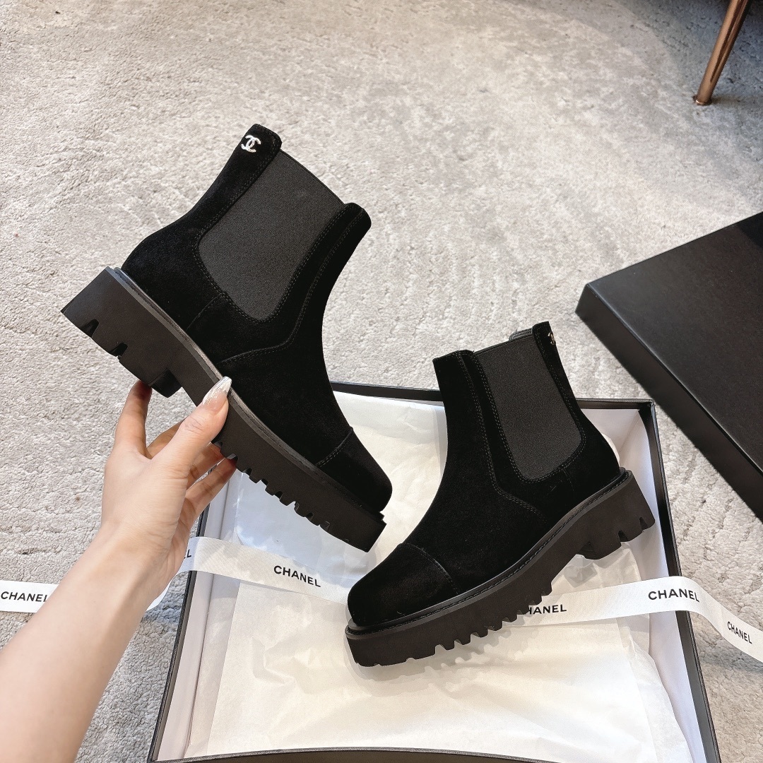 A pair of Chanel black suede platform Chelsea boots with a chunky lug sole and small silver CC logo, displayed with original luxury packaging. - Hình 6
