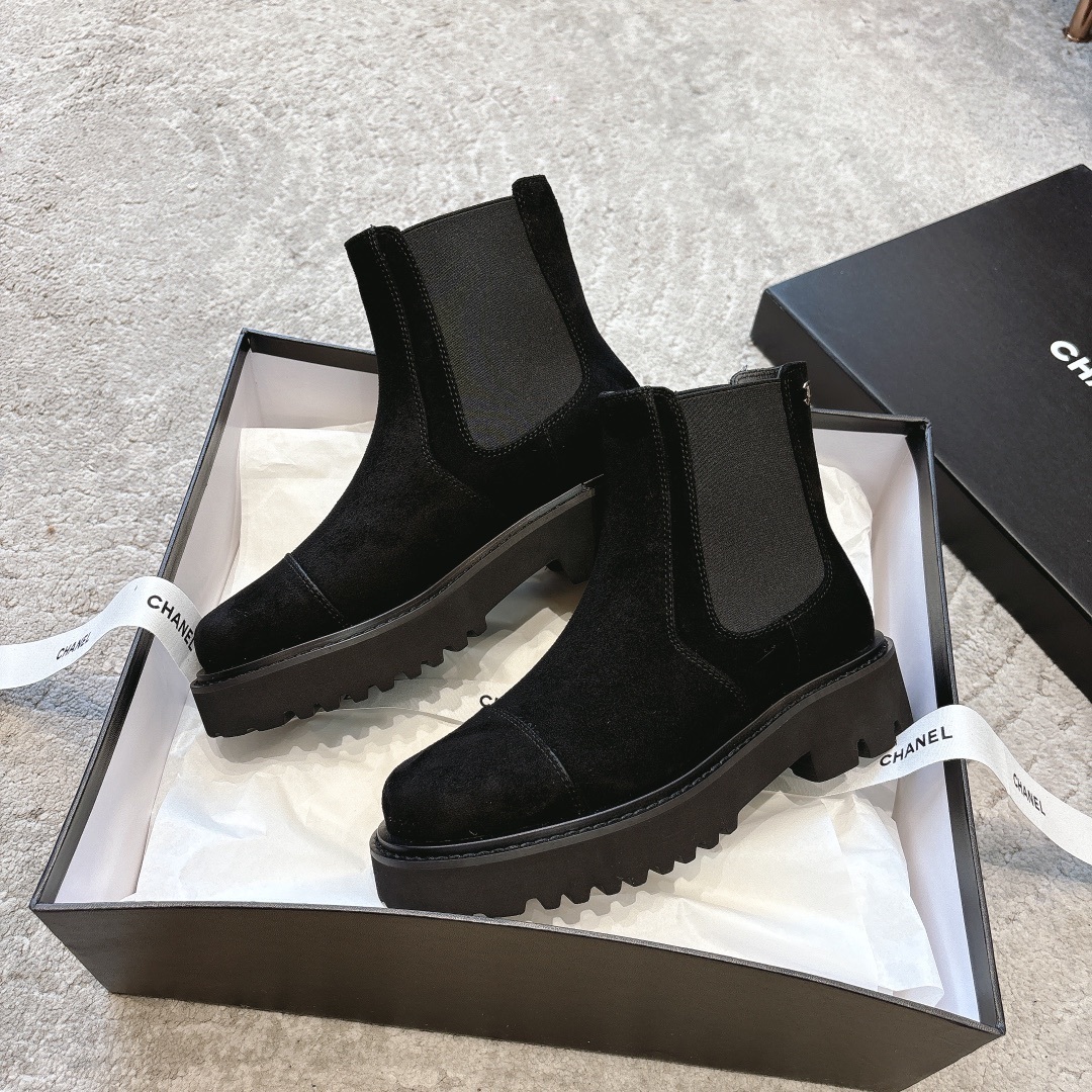 A pair of Chanel black suede platform Chelsea boots with a chunky lug sole and small silver CC logo, displayed with original luxury packaging. - Hình 5