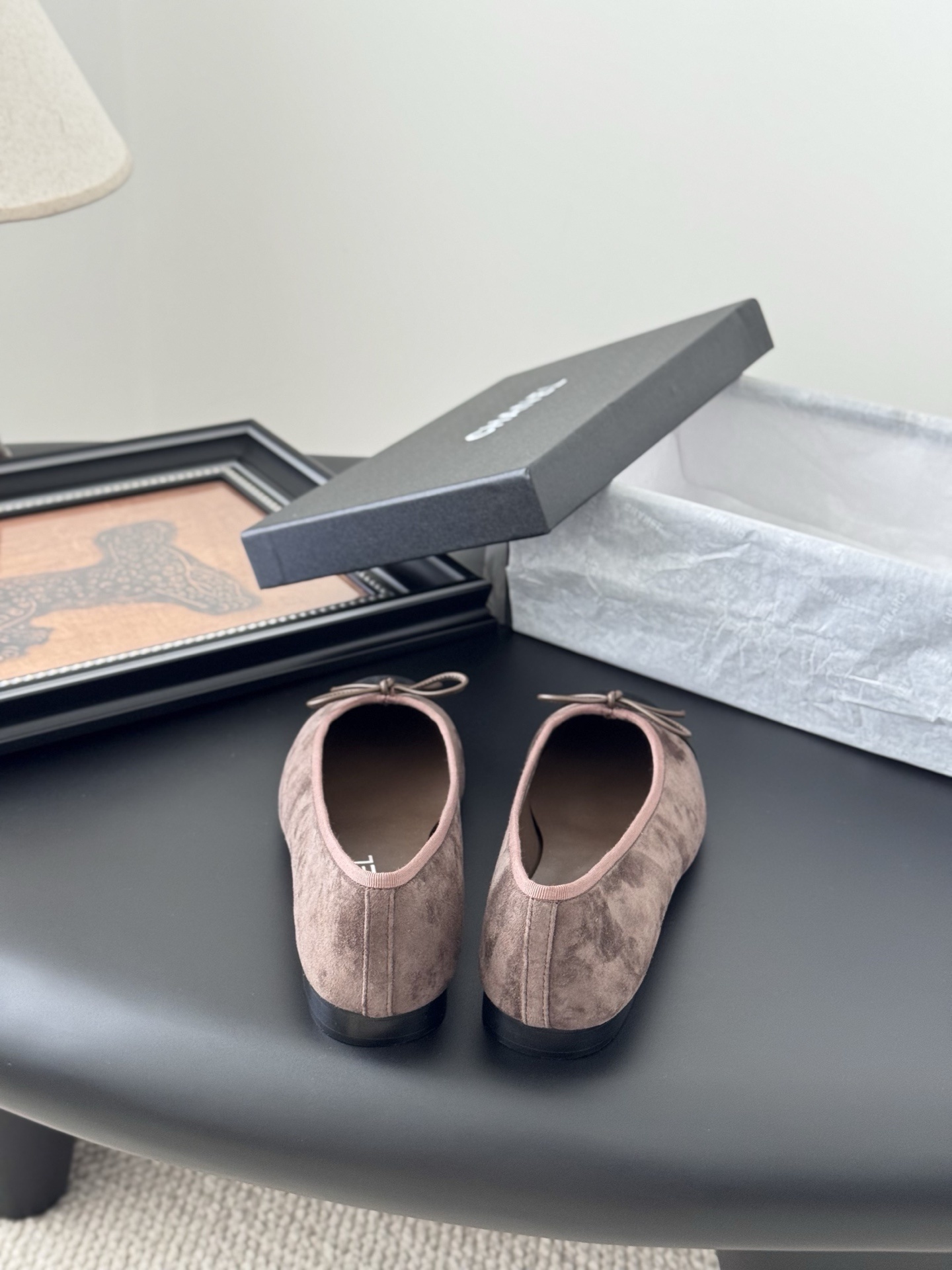 Luxury Chanel brown suede ballerina flats with black cap toe and bow detail placed next to a Chanel shoe box. - Hình 6