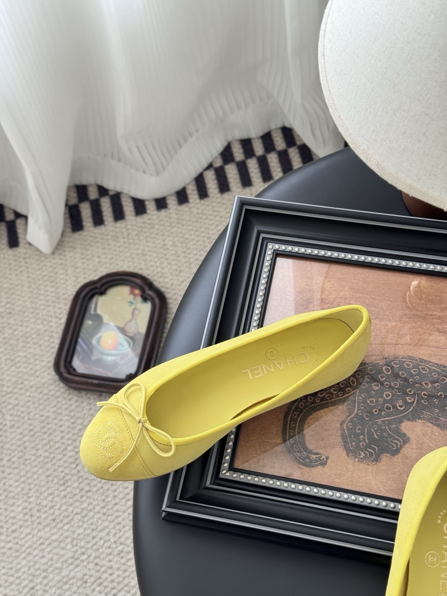 A pair of yellow Chanel suede ballerina flats with a bow and embroidered logo next to their original black box. - Hình 8