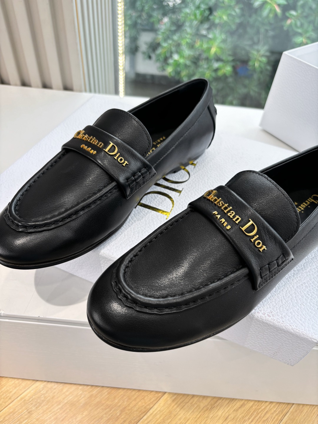 Pair of Christian Dior black leather loafers with gold signature logo in a white box - Hình 8