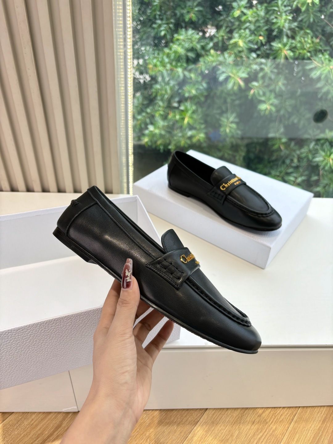 Pair of Christian Dior black leather loafers with gold signature logo in a white box - Hình 3