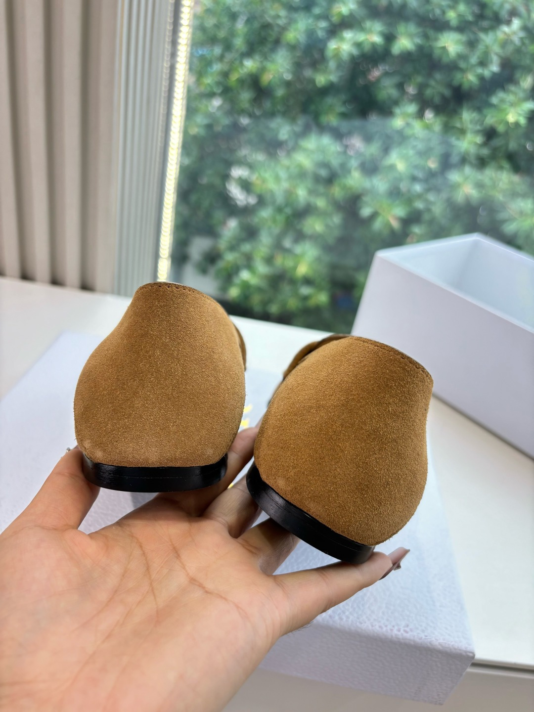 A pair of Christian Dior tan suede loafers with gold logo lettering displayed in a white Dior box. - Hình 9