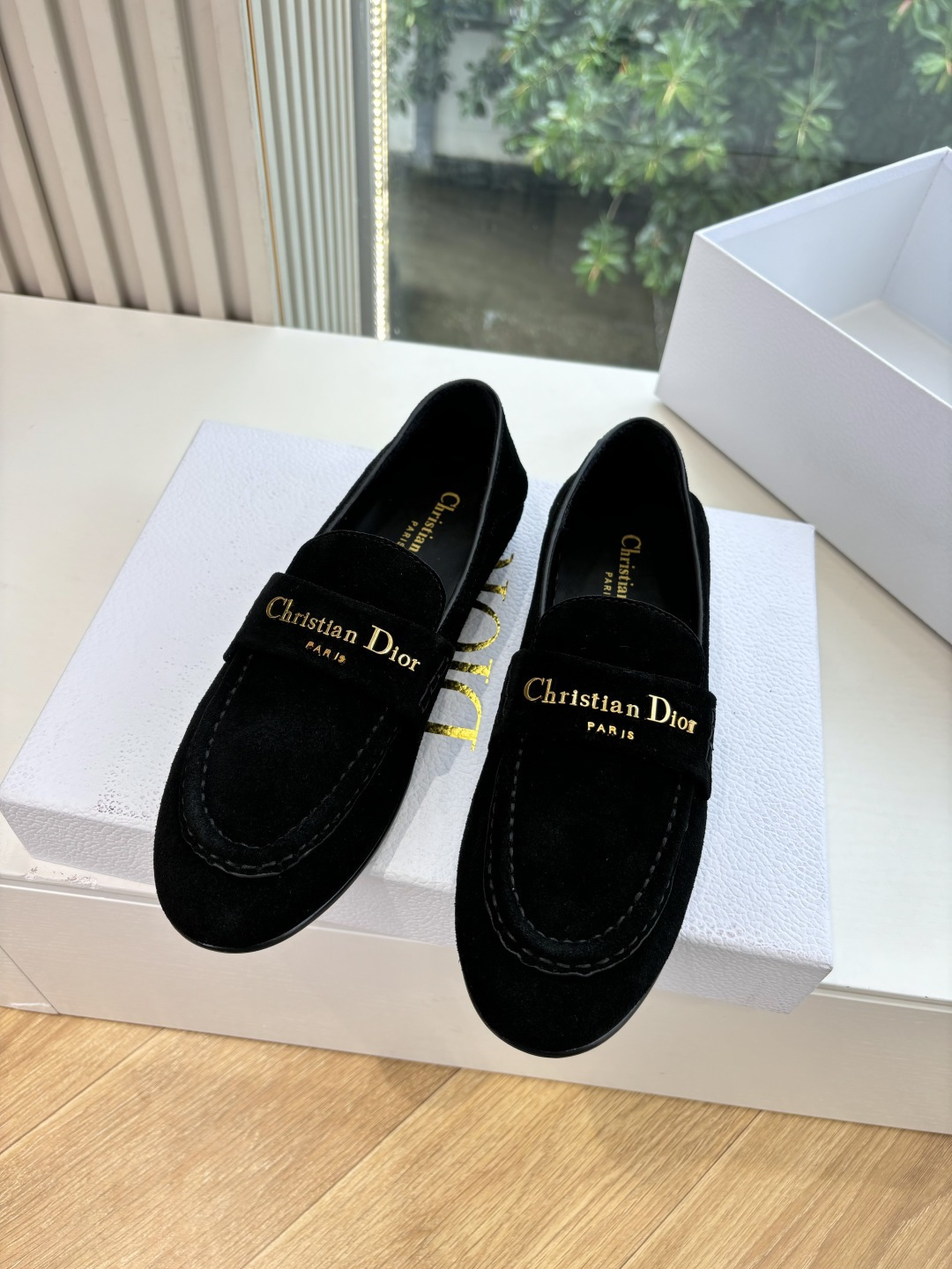 A pair of Christian Dior black suede loafers with gold signature logo in a white luxury box - Hình 4