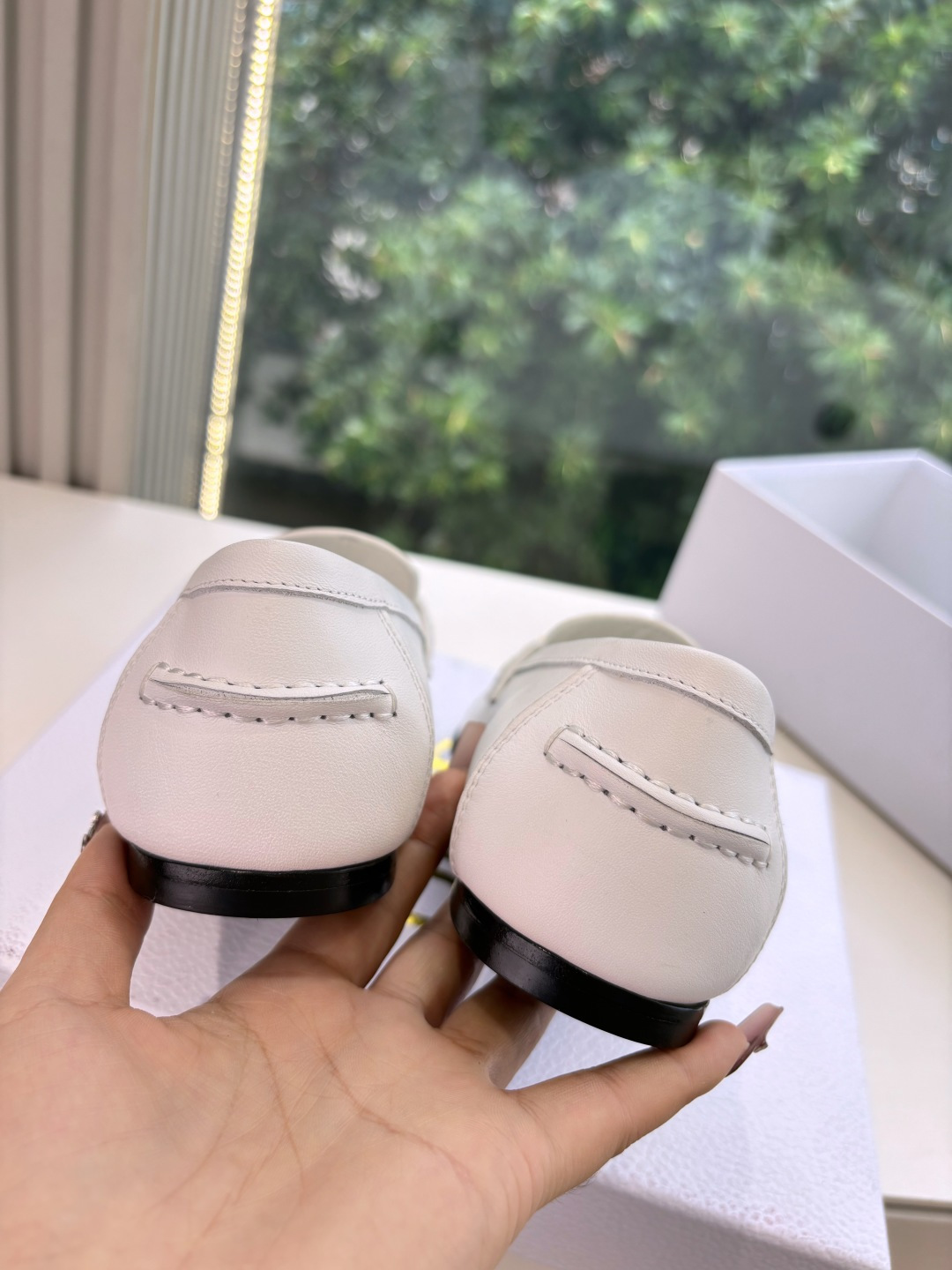 A pair of elegant white Christian Dior leather loafers with gold-tone signature logo in a luxury white gift box. - Hình 8