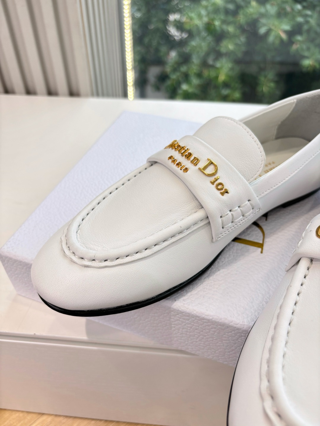 A pair of elegant white Christian Dior leather loafers with gold-tone signature logo in a luxury white gift box. - Hình 7