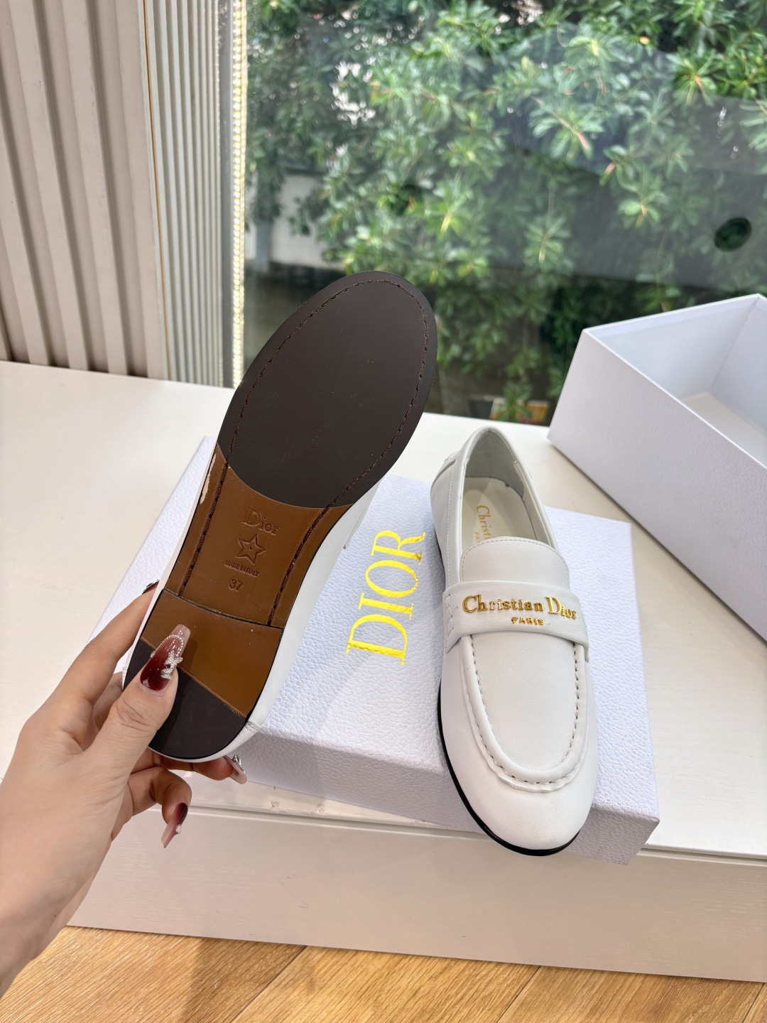 A pair of elegant white Christian Dior leather loafers with gold-tone signature logo in a luxury white gift box. - Hình 6