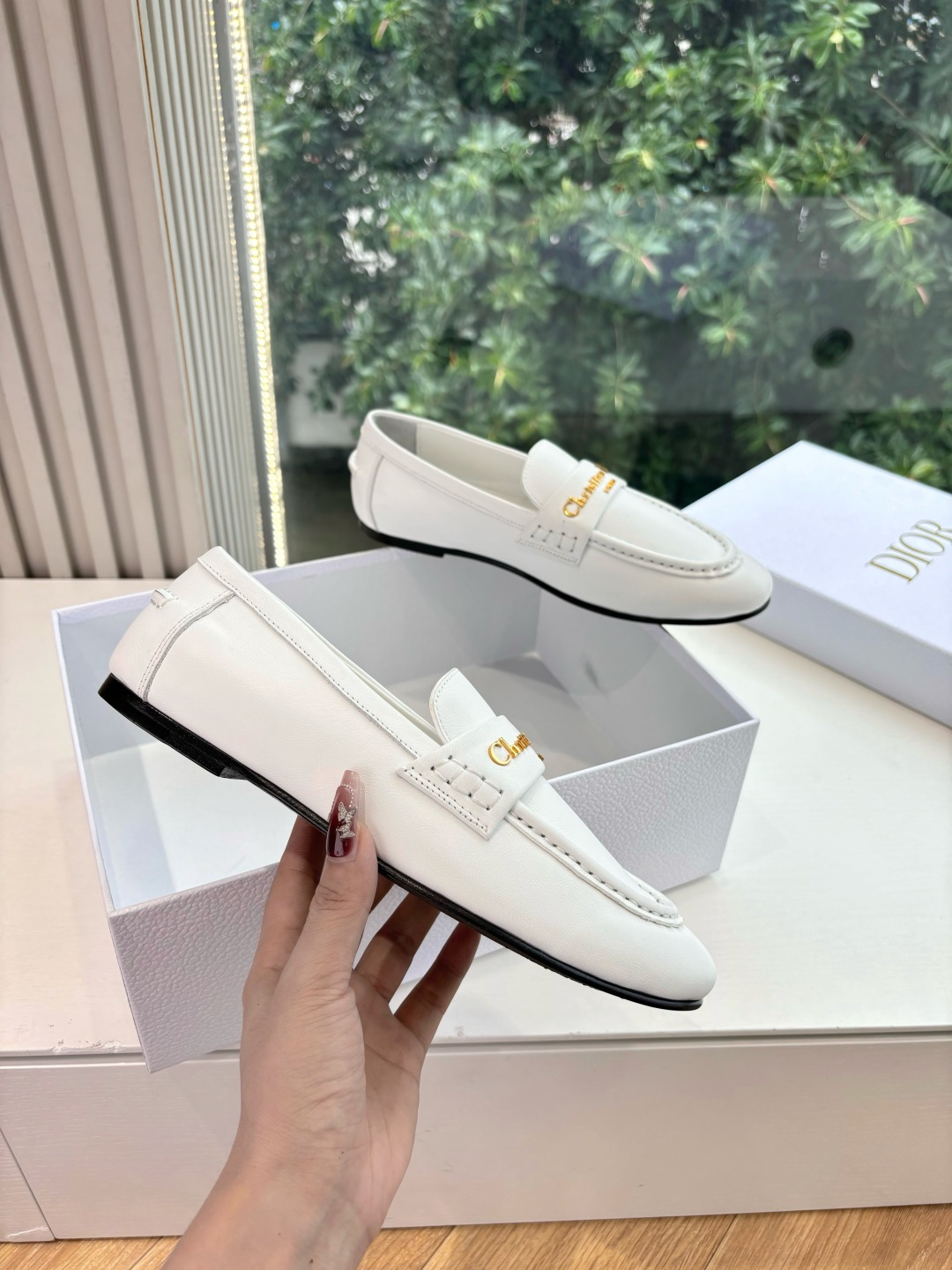 A pair of elegant white Christian Dior leather loafers with gold-tone signature logo in a luxury white gift box. - Hình 3