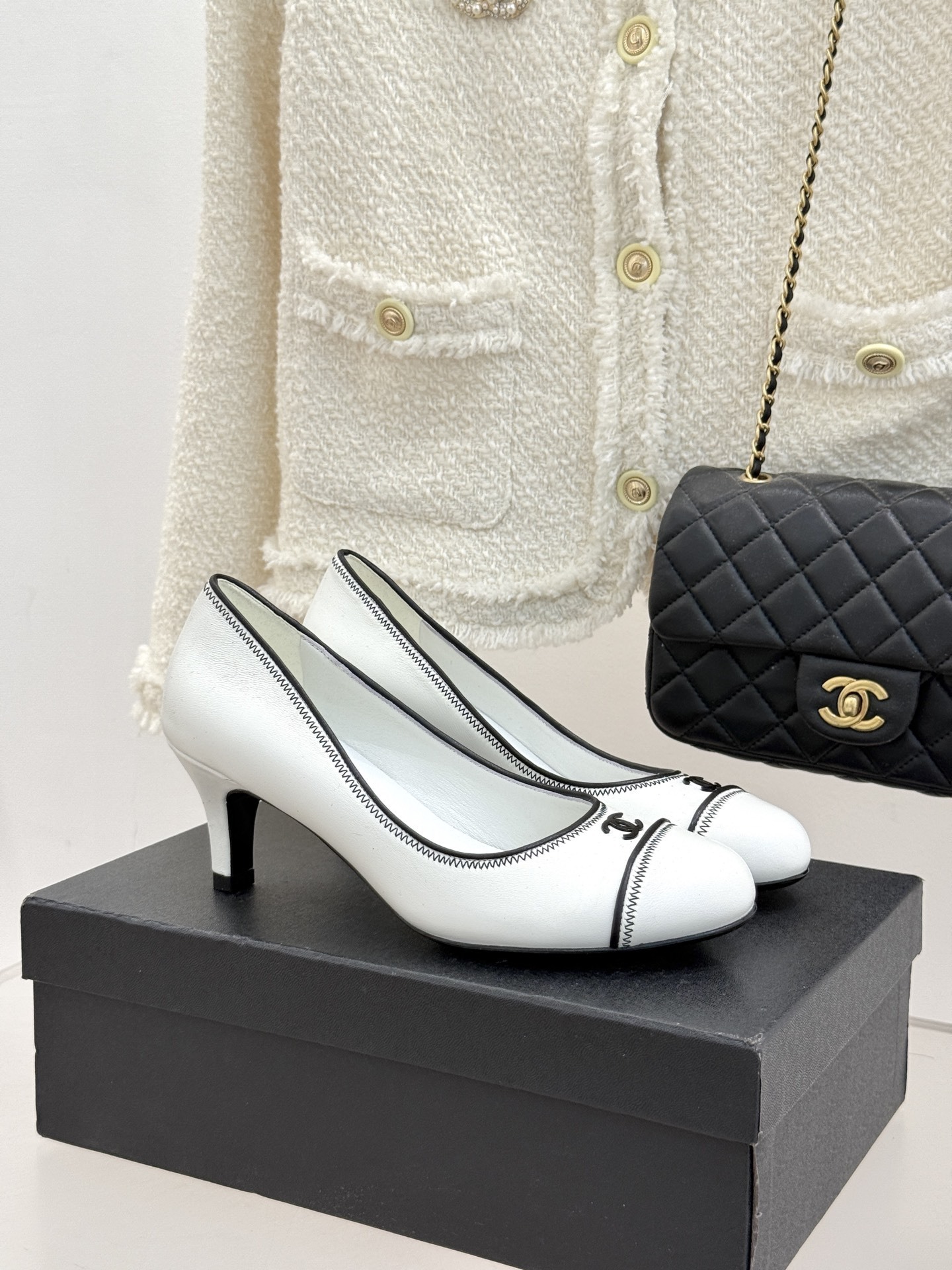 Classic Chanel White Leather Kitten Heel Pumps with Black Trim