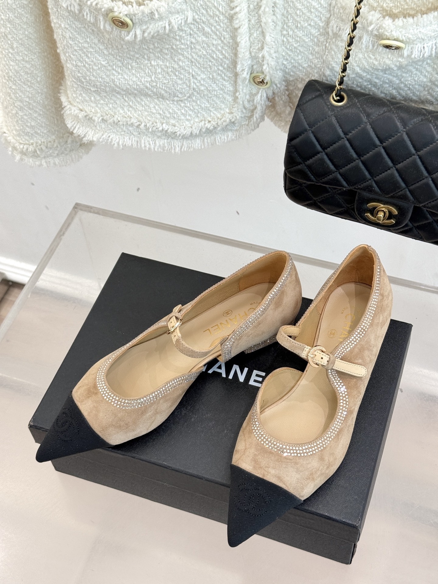 Chanel beige suede Mary Jane flats with black pointed cap-toes and crystal rhinestone trim displayed on a black box. - Hình 2