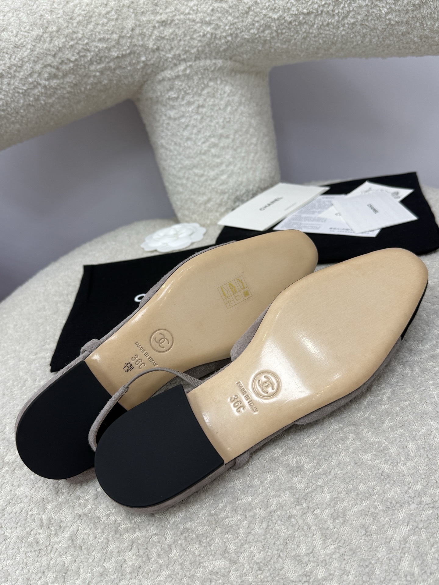 A pair of Chanel two-tone grey and black suede slingback flats displayed with branded dust bags and authentication papers. - Hình 9