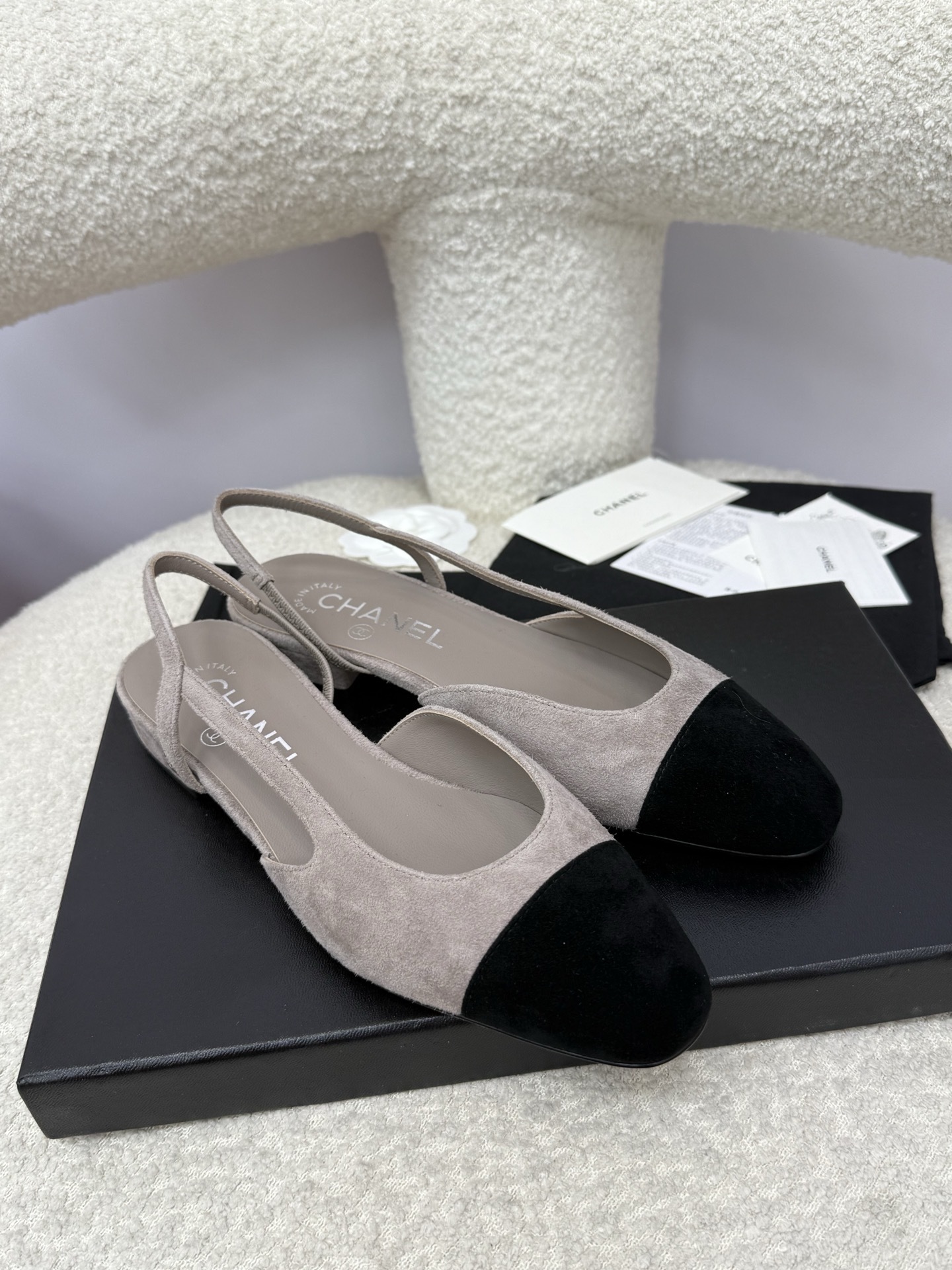 A pair of Chanel two-tone grey and black suede slingback flats displayed with branded dust bags and authentication papers. - Hình 6
