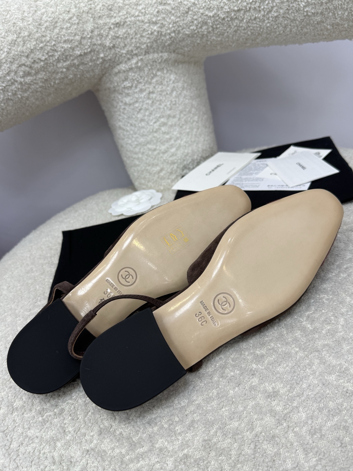Pair of Chanel two-tone slingback flats in brown suede with burgundy cap toe on a white textured surface with packaging. - Hình 9