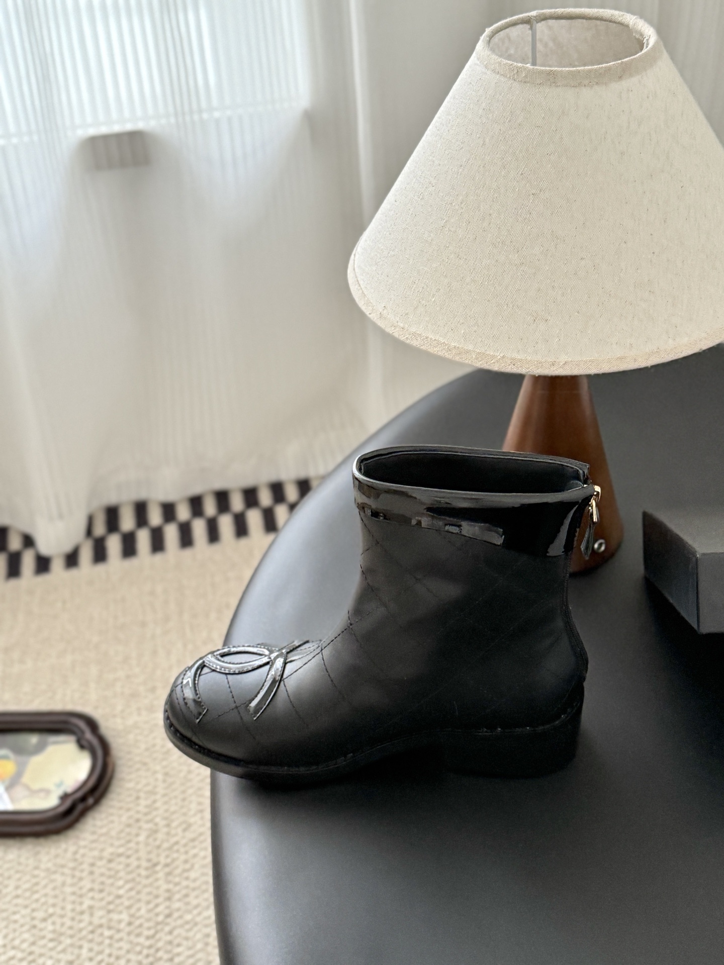 Pair of black Chanel quilted leather ankle boots with patent leather CC logo toe caps and back zippers - Hình 8