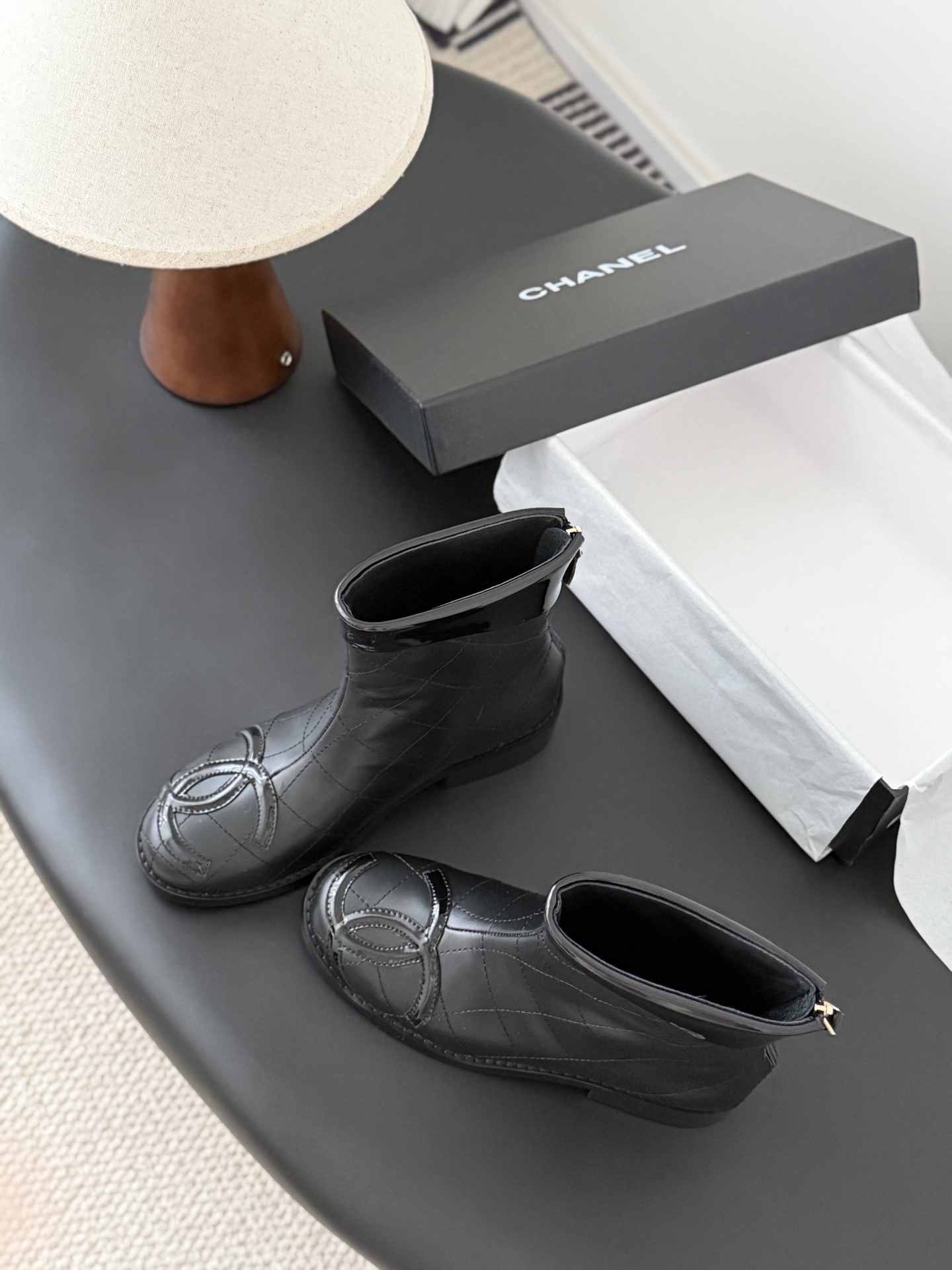 Pair of black Chanel quilted leather ankle boots with patent leather CC logo toe caps and back zippers - Hình 6