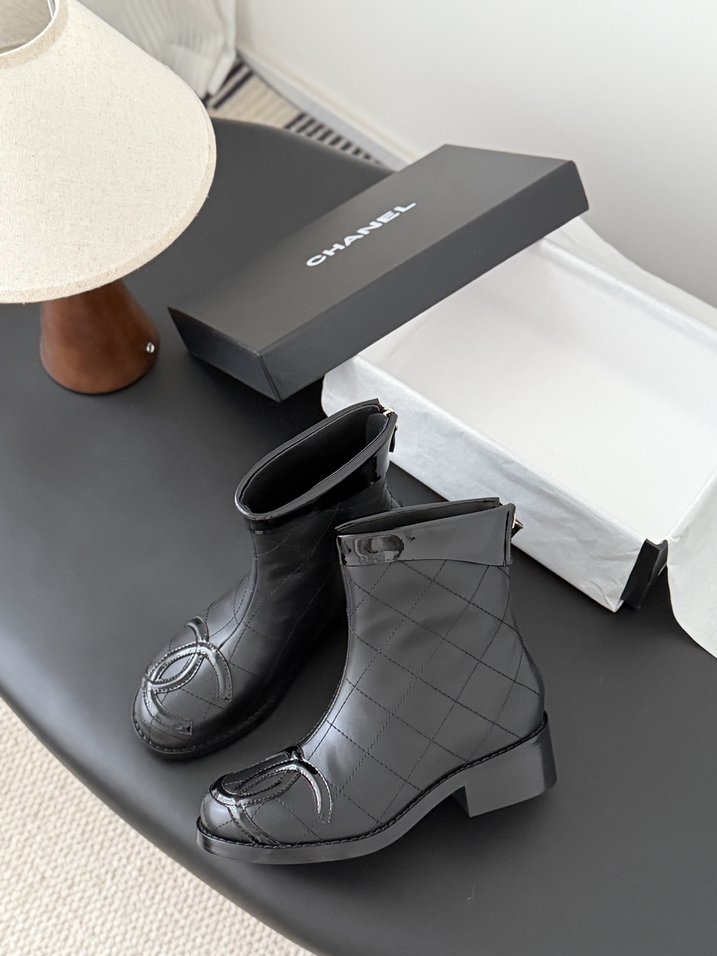 Pair of black Chanel quilted leather ankle boots with patent leather CC logo toe caps and back zippers - Hình 4