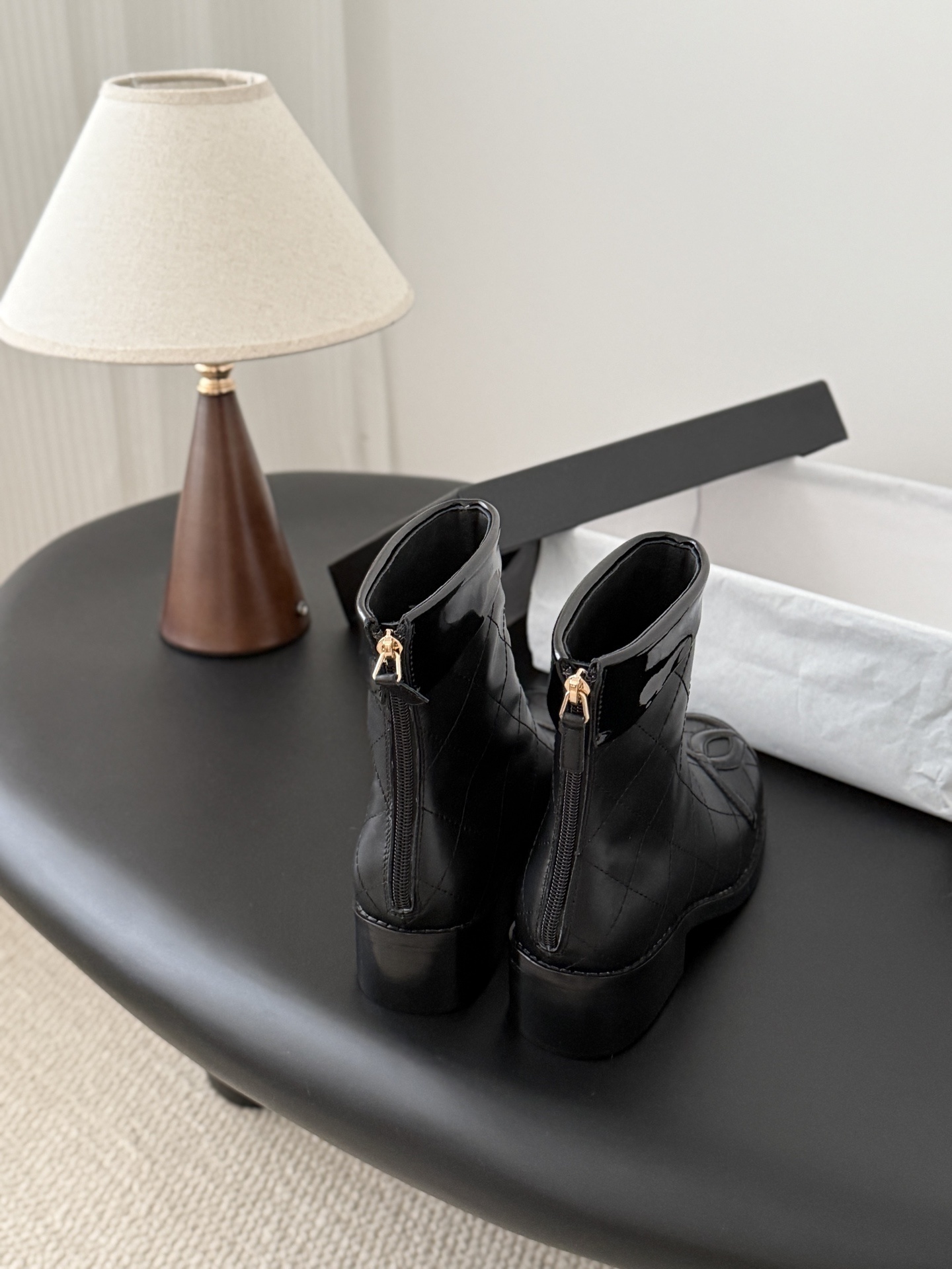 Pair of black Chanel quilted leather ankle boots with patent leather CC logo toe caps and back zippers - Hình 3