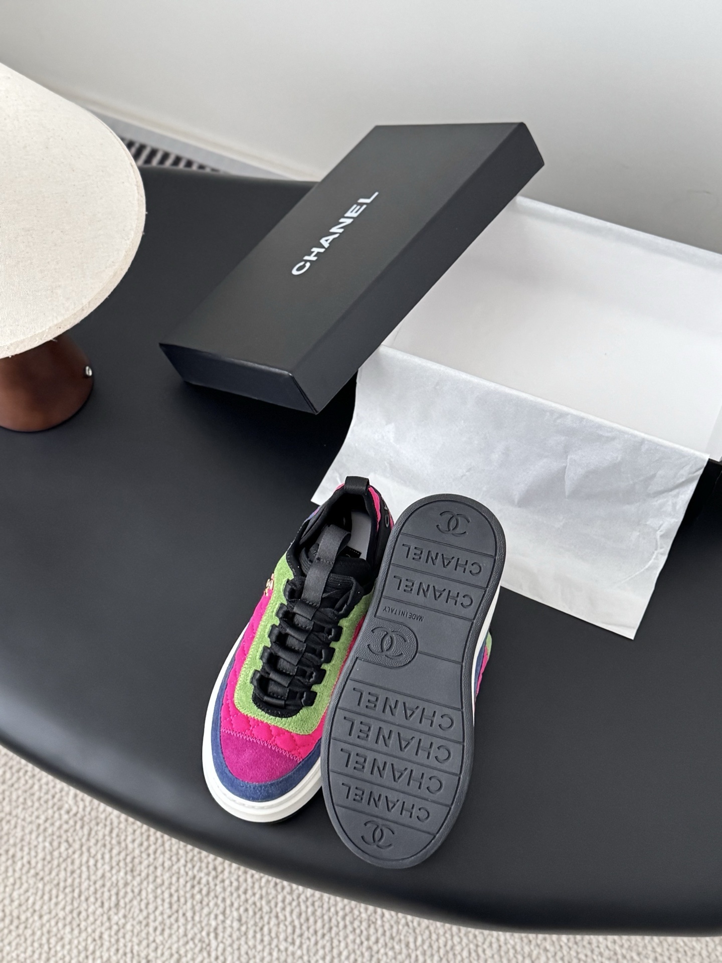 A pair of Chanel multicolor platform sneakers with pink, green, and blue quilted panels next to a black Chanel box. - Hình 4