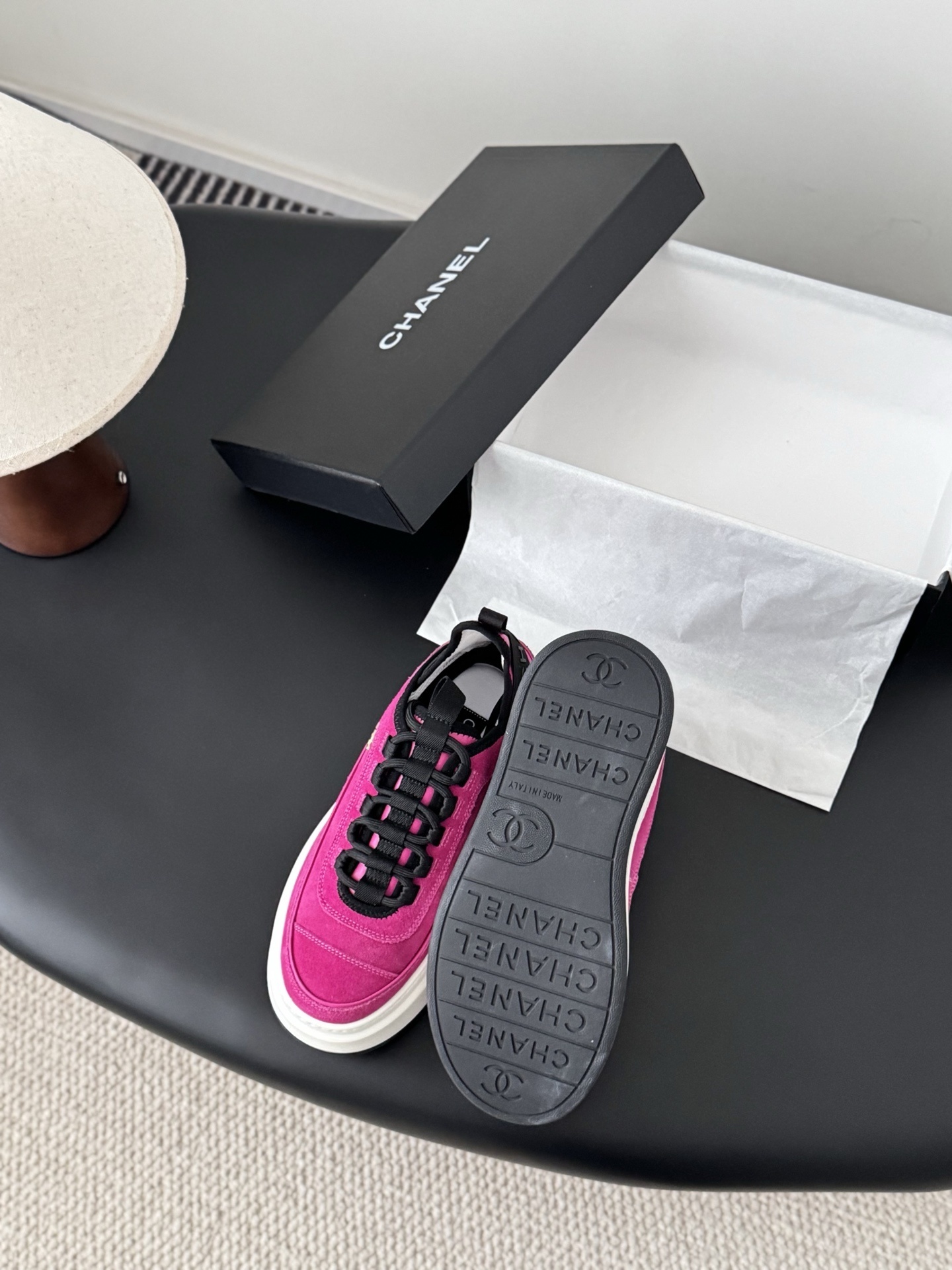 Pair of vibrant Chanel pink suede platform sneakers with gold CC logo displayed next to a black Chanel brand box. - Hình 4