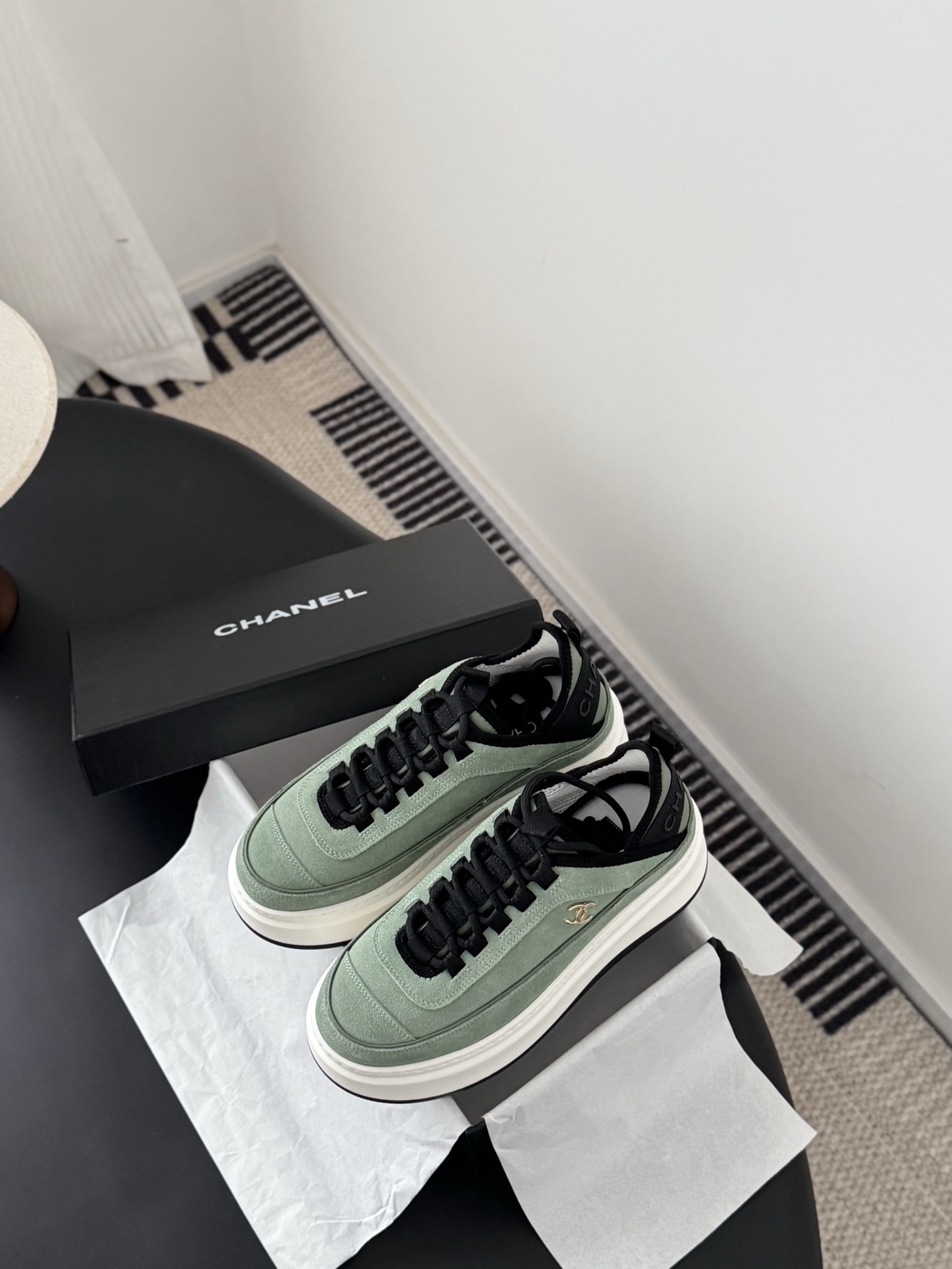 Chanel mint green suede sneakers with chunky white platform soles and black laces next to a Chanel box. - Hình 6
