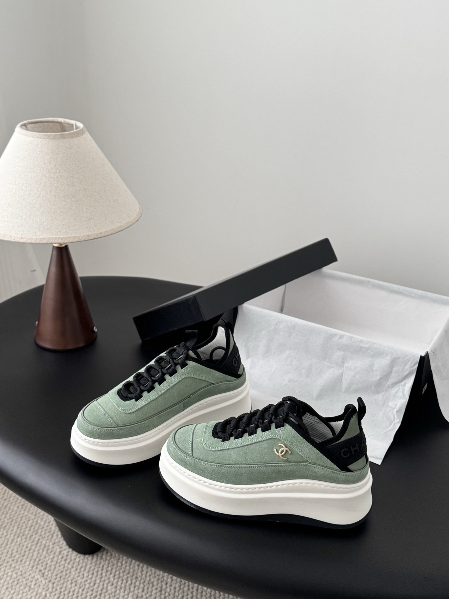 Chanel mint green suede sneakers with chunky white platform soles and black laces next to a Chanel box. - Hình 2