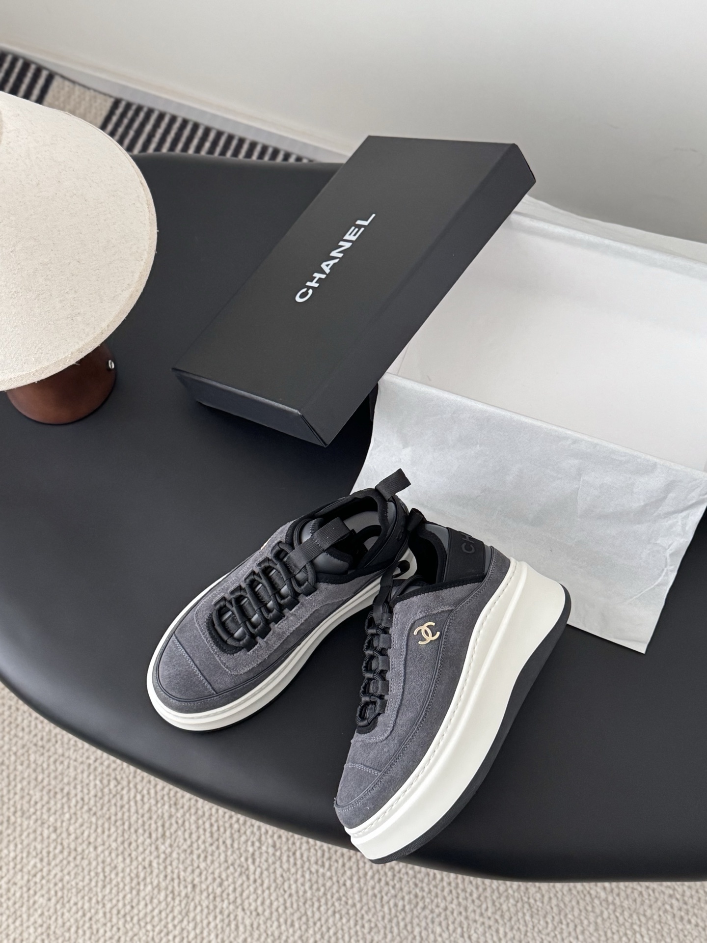 Luxury Chanel platform sneakers in grey suede with white chunky soles and gold CC logo, shown with original black box. - Hình 3