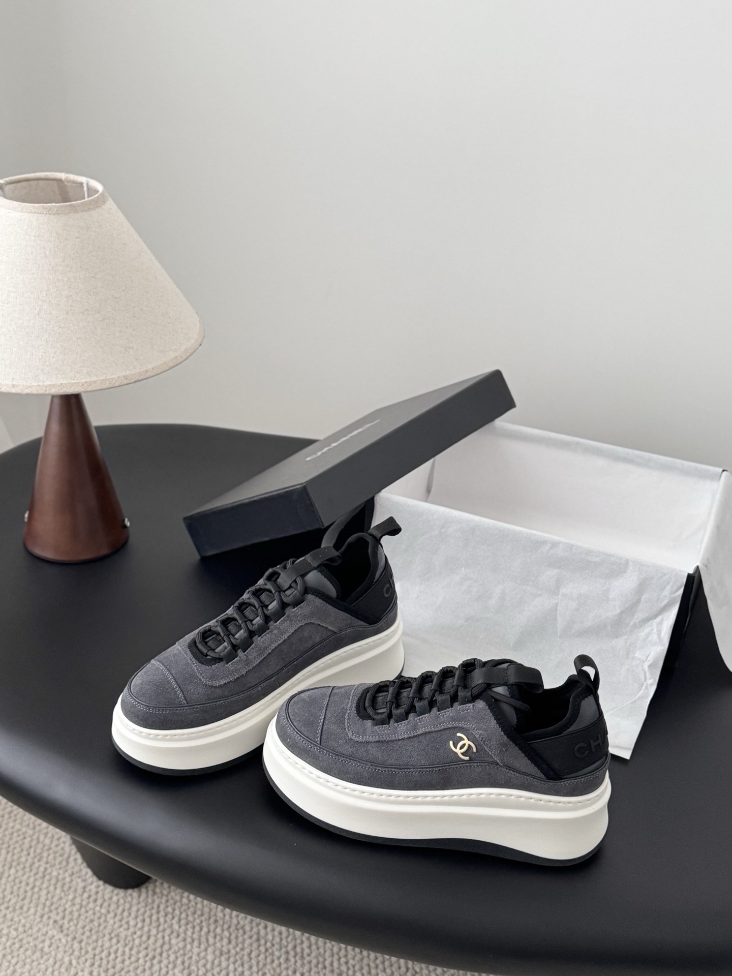Luxury Chanel platform sneakers in grey suede with white chunky soles and gold CC logo, shown with original black box. - Hình 2