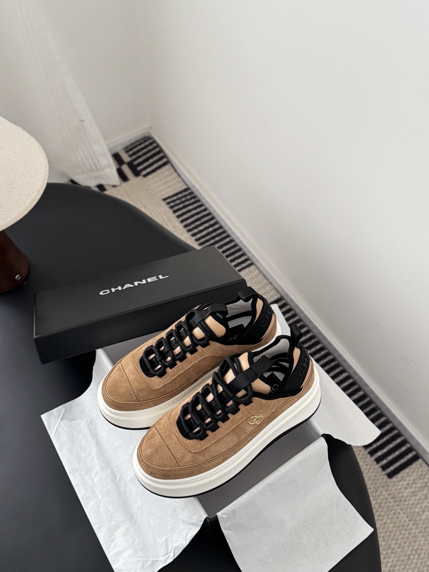 Pair of Chanel tan suede platform sneakers with black laces and thick white soles, featuring a gold CC logo on the side. - Hình 6