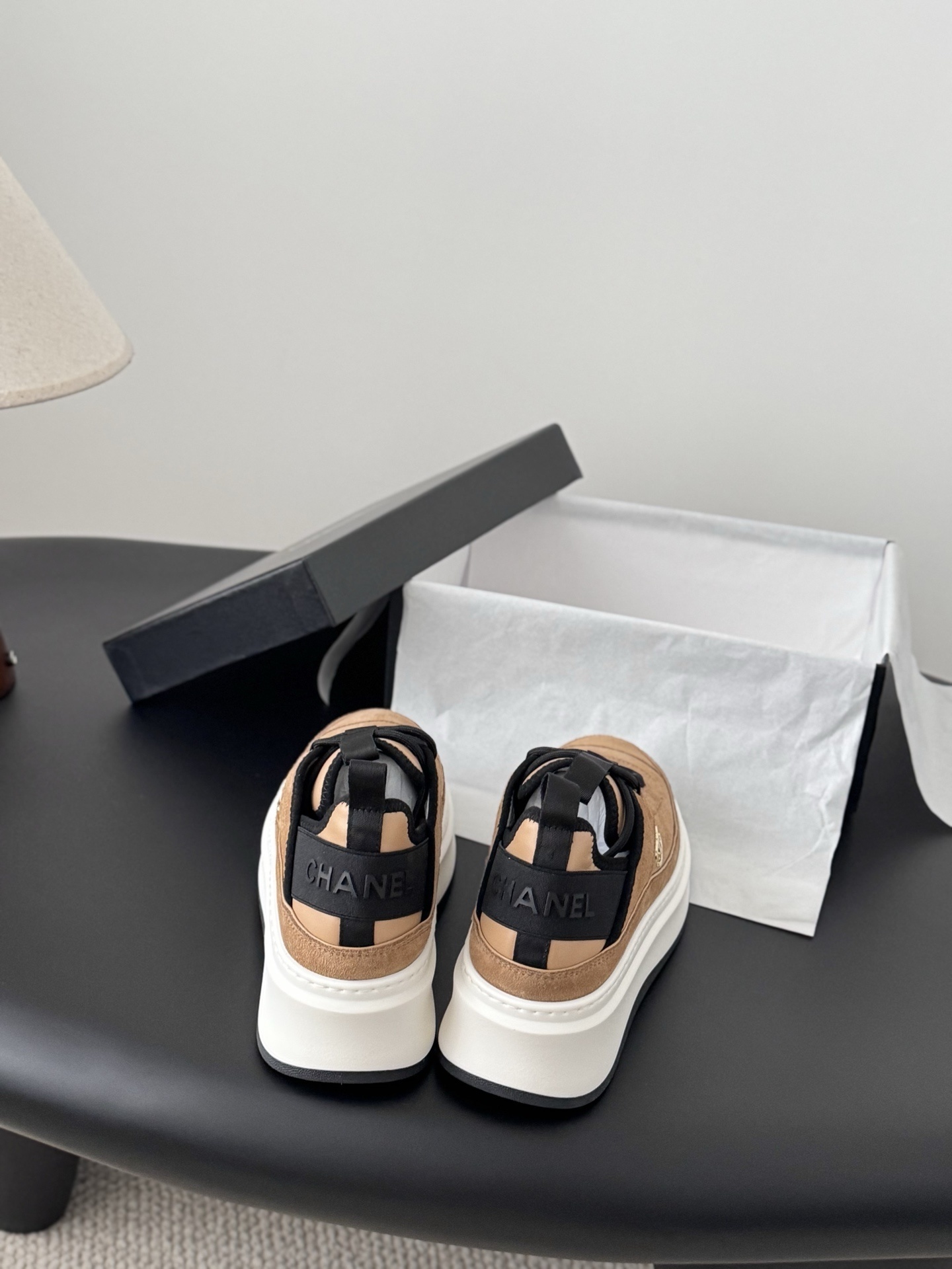 Pair of Chanel tan suede platform sneakers with black laces and thick white soles, featuring a gold CC logo on the side. - Hình 5